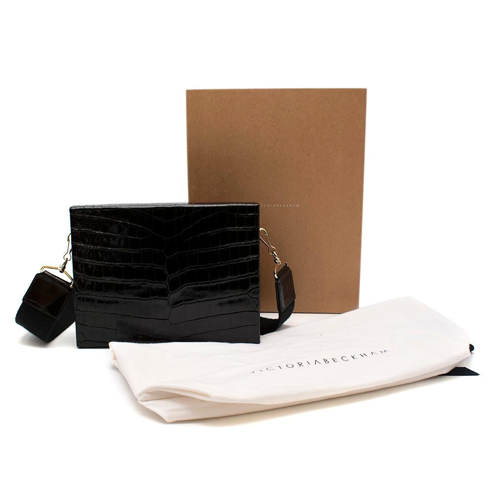 Victoria Beckham Alligator Large Show Box SS/15

- Luxurious black alligator with a glossy finish
- Detachable utilitarian-style canvas shoulder strap
- Gold shiny hardware
- Suede black lining
- Mini pouch inside
- Box looking bag

Fabric
