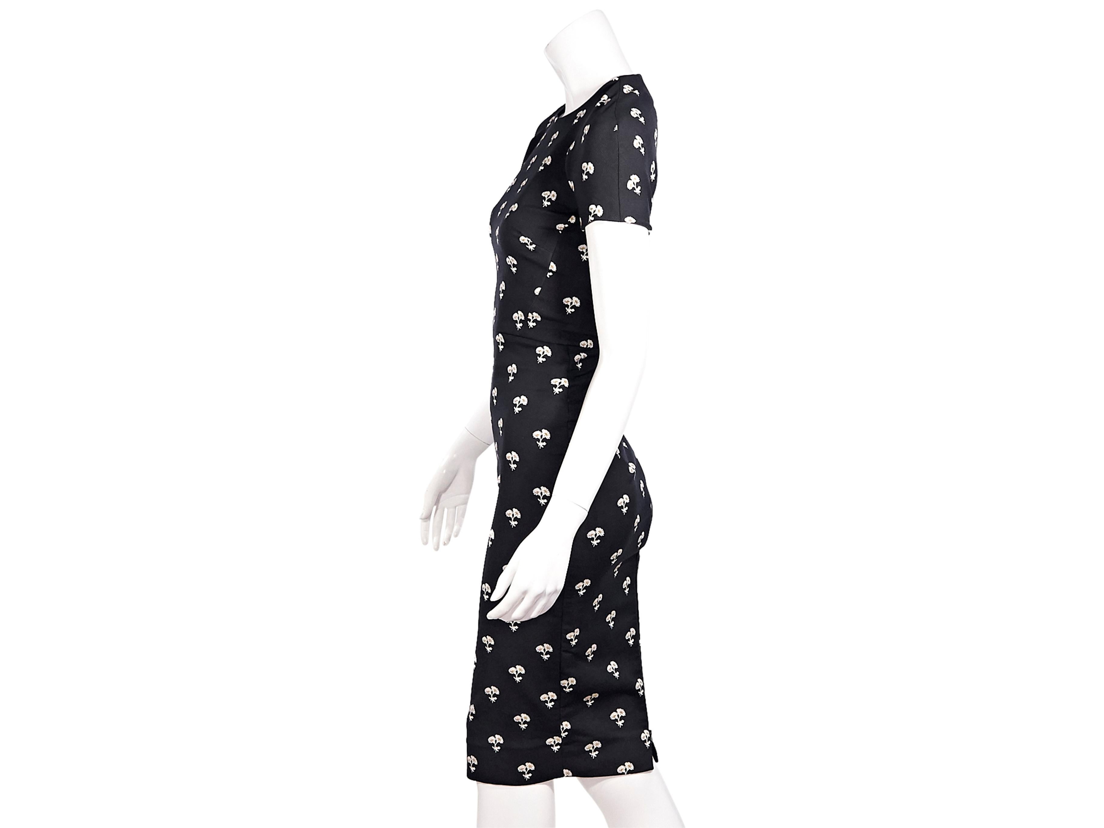 Product details:  Black and white dandelion-embroidered sheath midi dress by Victoria Beckham.  Stretch cotton-blend fabrication.  Crewneck.  Short sleeves.  Exposed back zip closure.  Center back hem vent.  32