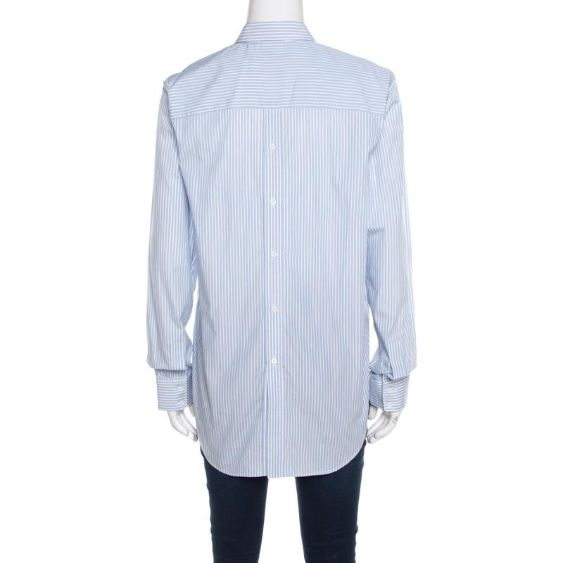 A fine blend of art and ever-changing fashion, this Victoria Beckham shirt is made for the lady in you. Time to add some subtle style to your wardrobe with this blue striped shirt. Made in cotton, this is just what you need to have a good time.

