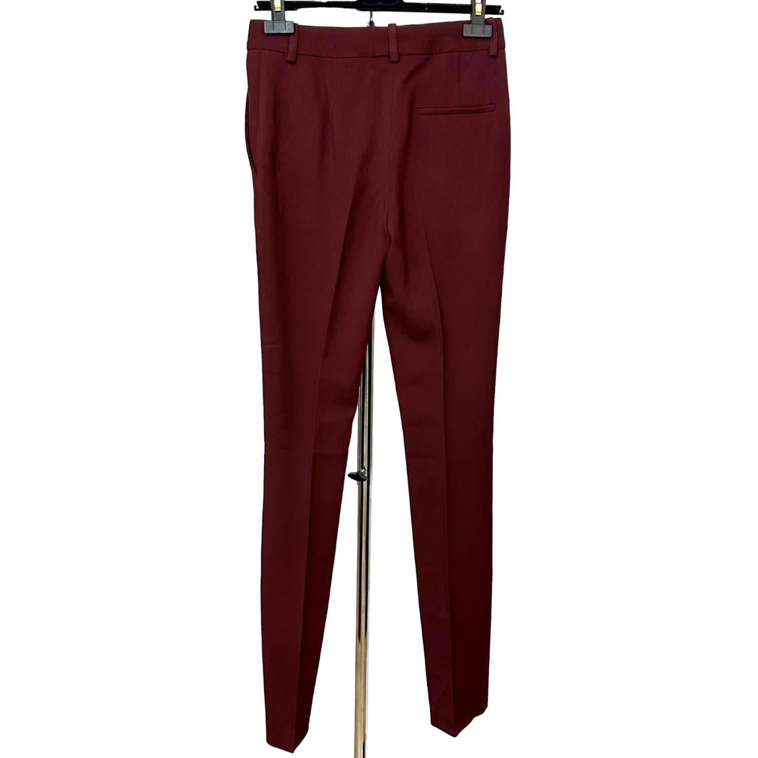 
GUARANTEED AUTHENTIC VICTORIA BECKHAM BORDEAUX WOOL TROUSERS

Details:
• Straight leg.
• Front side slant pockets.
• Front zipper, hook and covered button closure.
• Belt loops.
• Creases.
• Classic silhouette.

Fabric: 100% Wool

Size: US