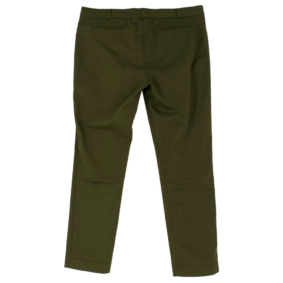Victoria Beckham Cotton Green Slim fit Trousers

- Green cotton trousers
- Crop length
- Slim fit 
- Unlined
- Hidden zip, button and hook fastening 
- Belt hoops
- Two front and back slip pockets 
- Stitched middle front line

Please note, these
