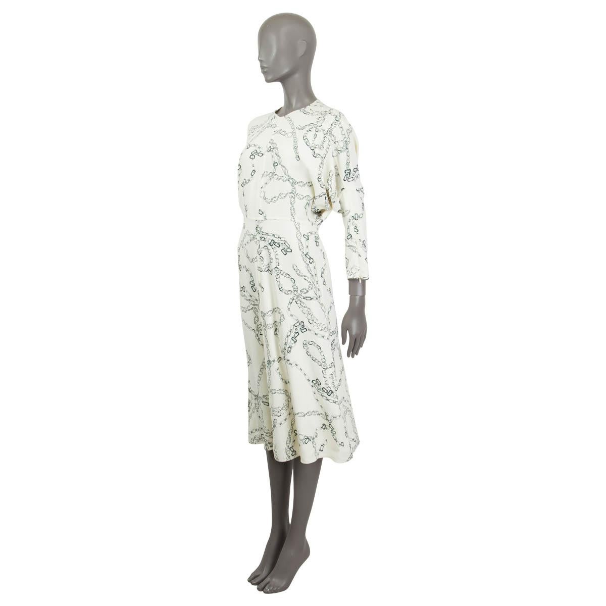 100% authentic Victoria Beckham chain-link print midi dress in cream and grey stretch viscose (96%) and elastane (4%). Features long dolman sleeves (sleeve measurement taken from the neck) with concealed zip cuffs. Opens with a concealed zipper and
