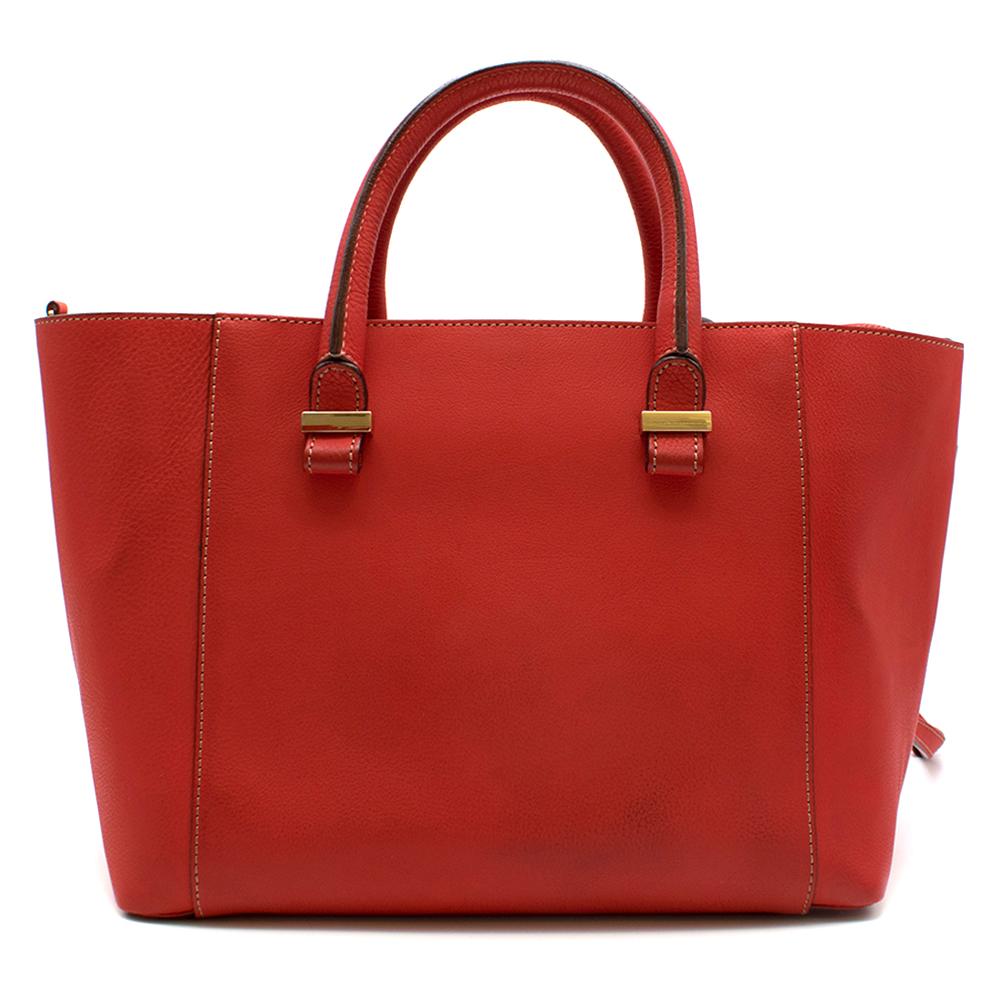 Victoria Beckham Red Liberty Leather Tote bag

- This fine leather tote bag is a elegant design suitable for the day and night
- It features red leather handles as well as a long red leather strap
- Interior pockets 
- Interior black material
