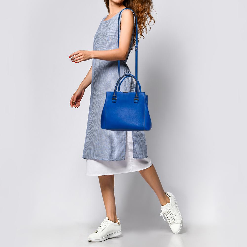 Designed expertly, this bag features a leather body. This contemporary designed bag can hold more than just essentials in its fabric-lined interior. Go for this Victoria Beckham handbag if you like to keep it simple yet stylish. This flamboyant blue