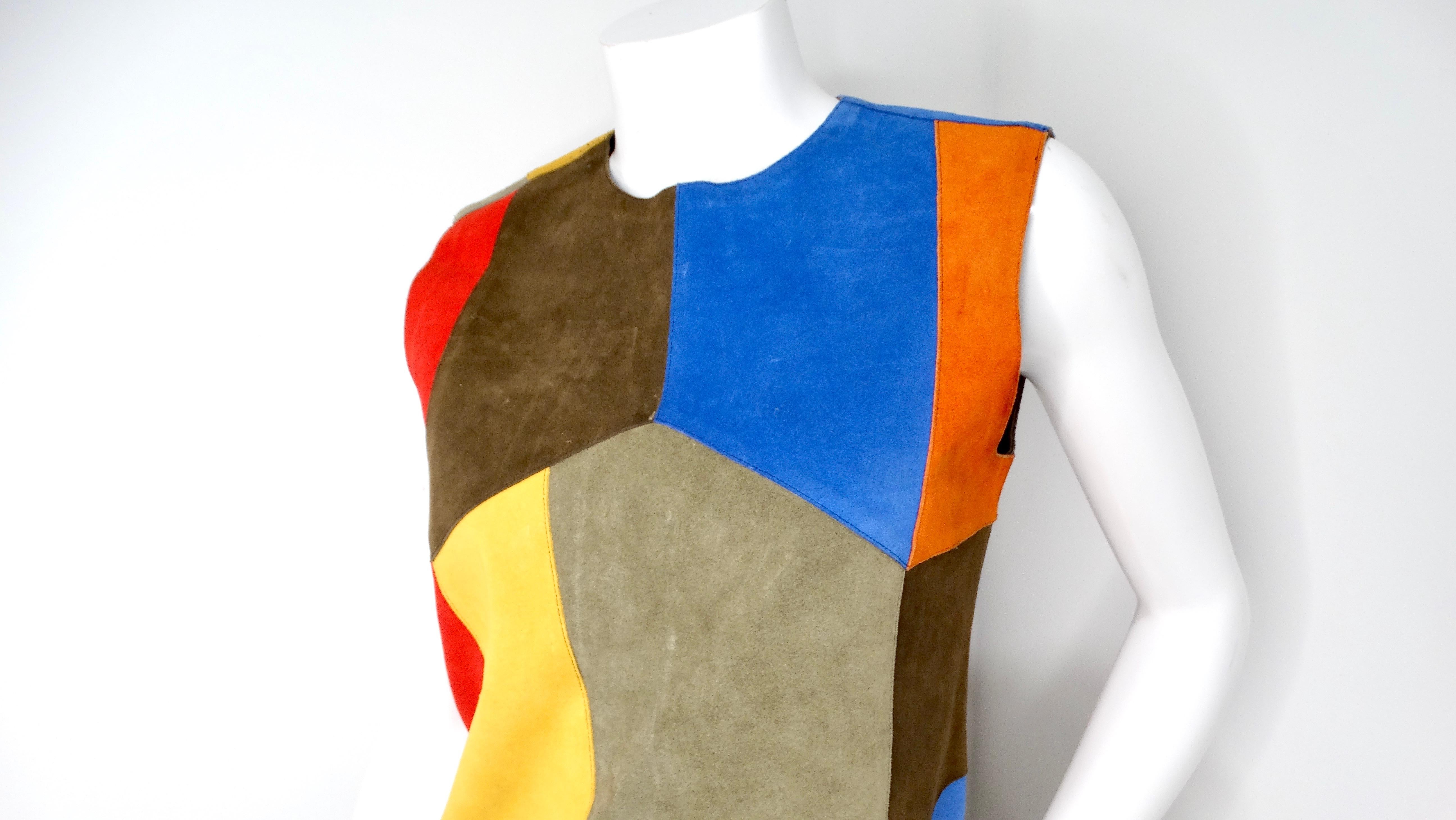 The Victoria Beckham Suede Multicolor Patchwork Dress showcases a stunning fusion of vibrant colors and vintage-inspired design, making it an eye-catching addition to any wardrobe. This exquisite sleeveless dress features a beautiful patchwork of
