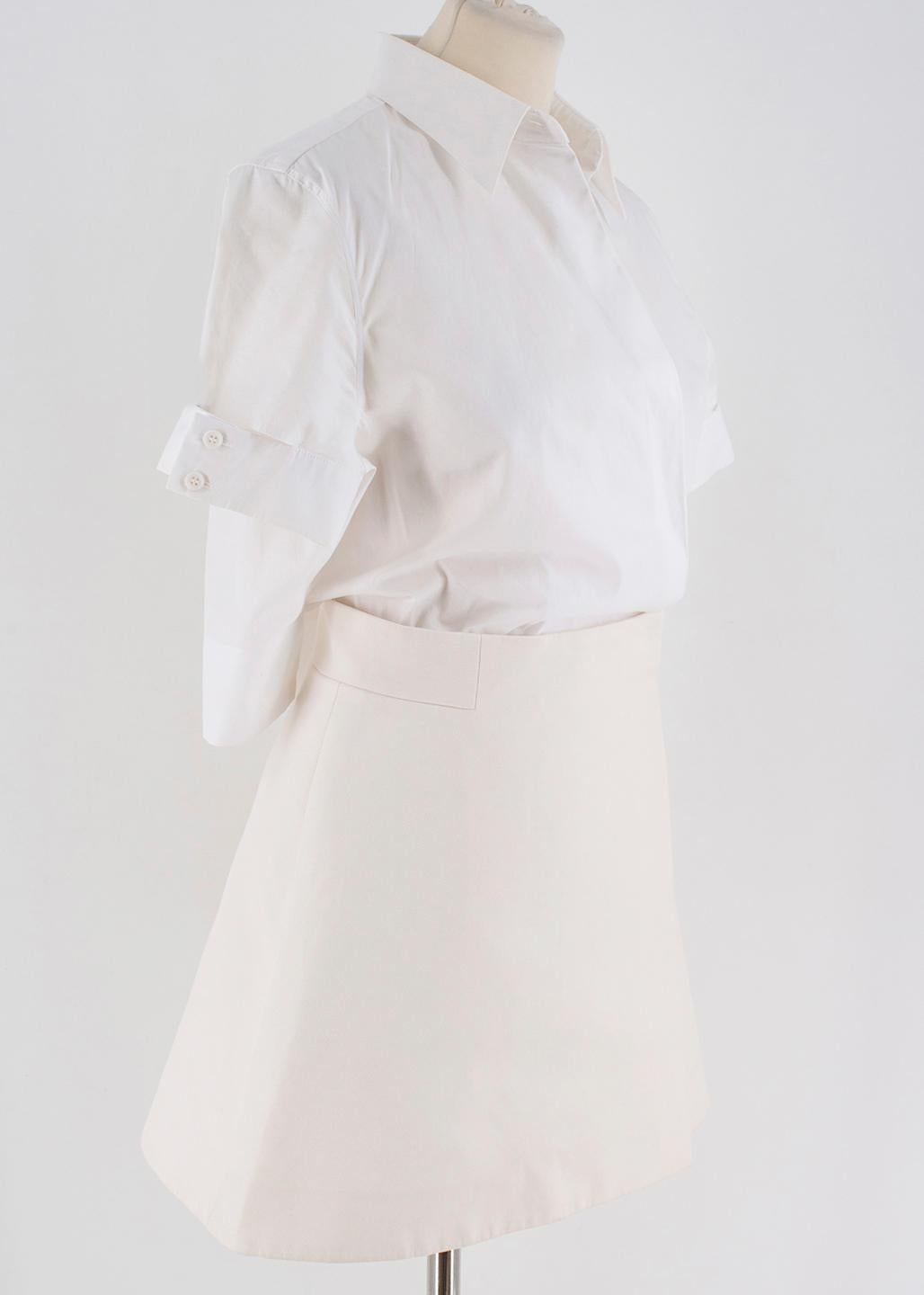 Victoria Beckham A-line Shirt Dress 

- A-line Shirt Dress
- Open Lapel Top
- Short Sleeved, buttoned 
- Beige Wrap Skirt Bottom
- Hook-and-eye clasp 
- 100% Cotton

Please note, these items are pre-owned and may show some signs of storage, even