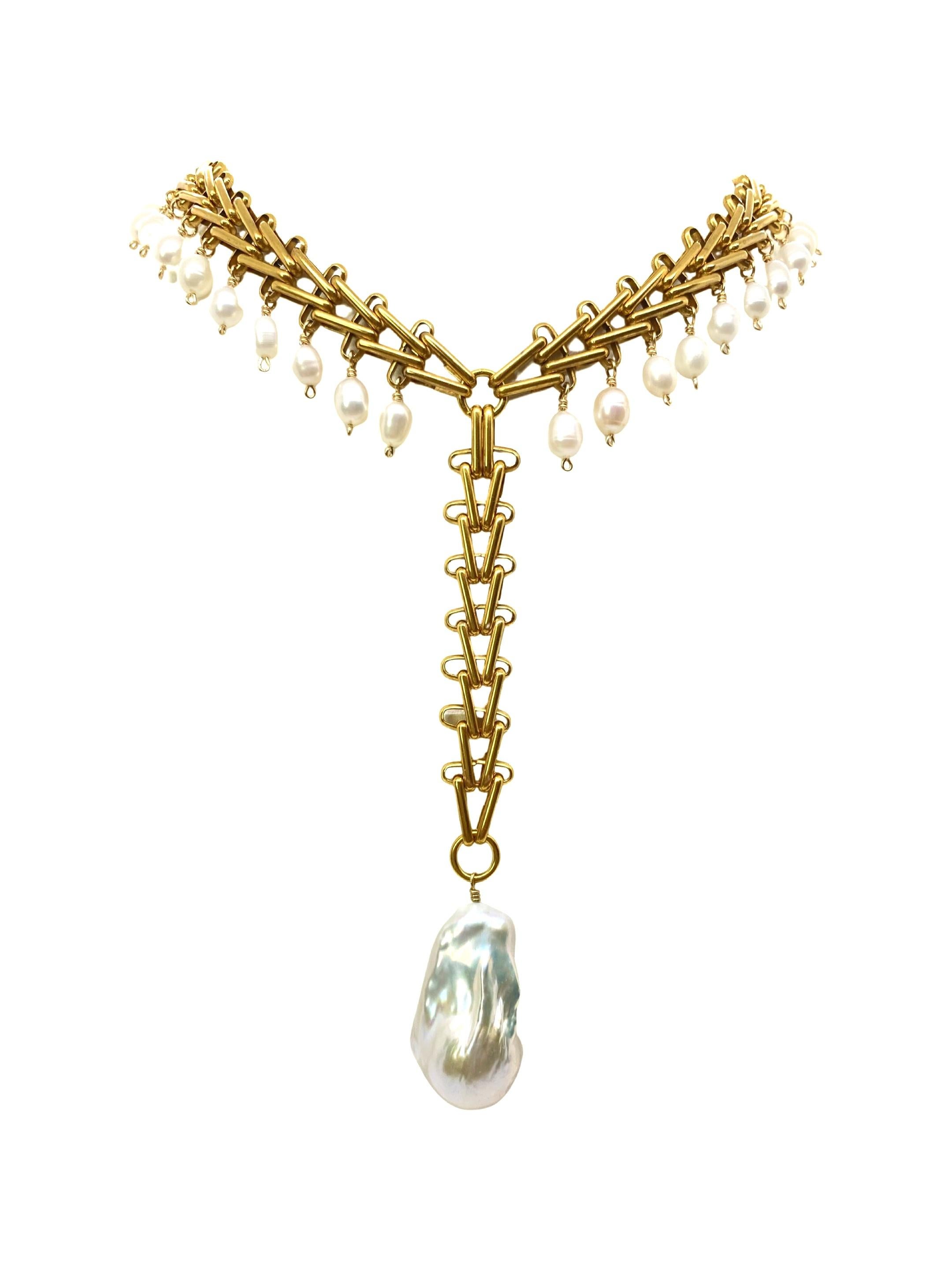 The Victoria necklace. V shaped chain necklace adorned with freshwater pearls and a large unique shape baroque pearl provides a dramatic statement to any outfit. 

Please note that no two pearls are exactly alike. Size, shape and color will vary in
