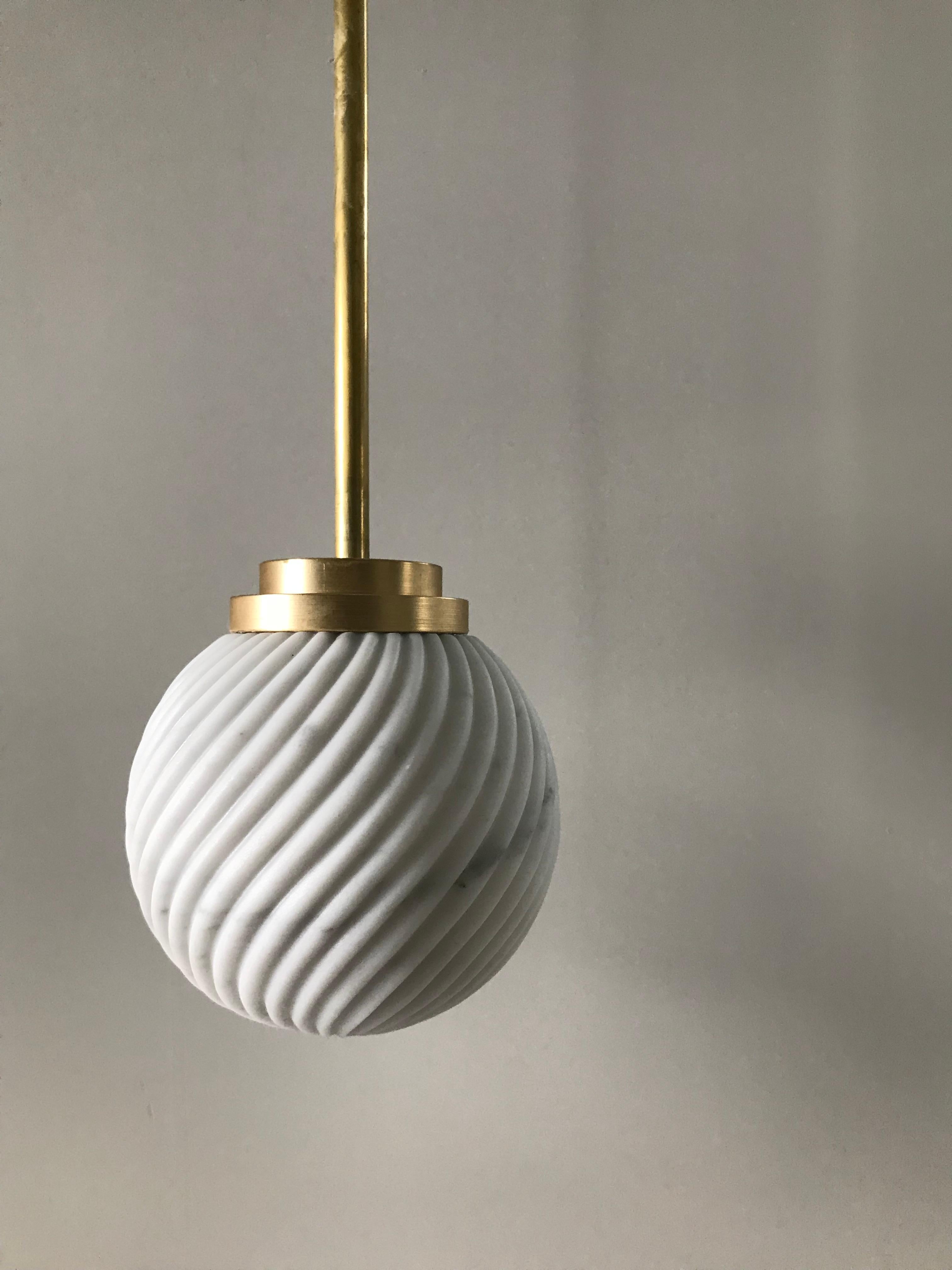 Victoria lighting celebrates the delicacy of Arabescato marble and brushed brass, protagonists of the iconic Victoria tea set. The collection is handmade in Italy and comprises a table lamp, a wall lamp, a pedant light and a chandelier of three