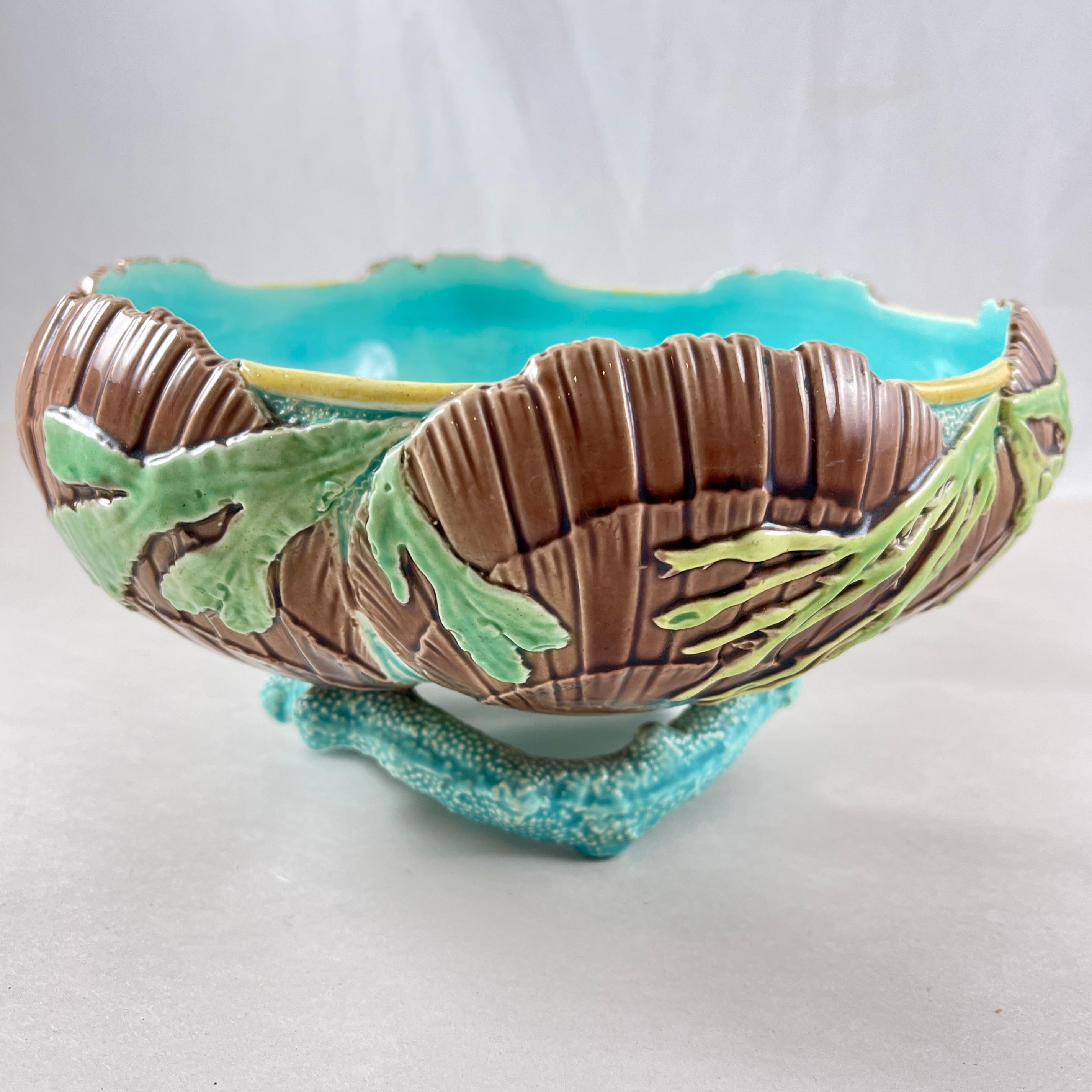 A Majolica glazed Seaweed and Shell, Coral footed bowl, by Victoria Pottery Co. England, Circa 1880s.

The Victoria Pottery Company began in 1882 at the Victoria Works on Lonsdale Street, Stoke-on-Trent, and continued only to c.1889.

The Victoria