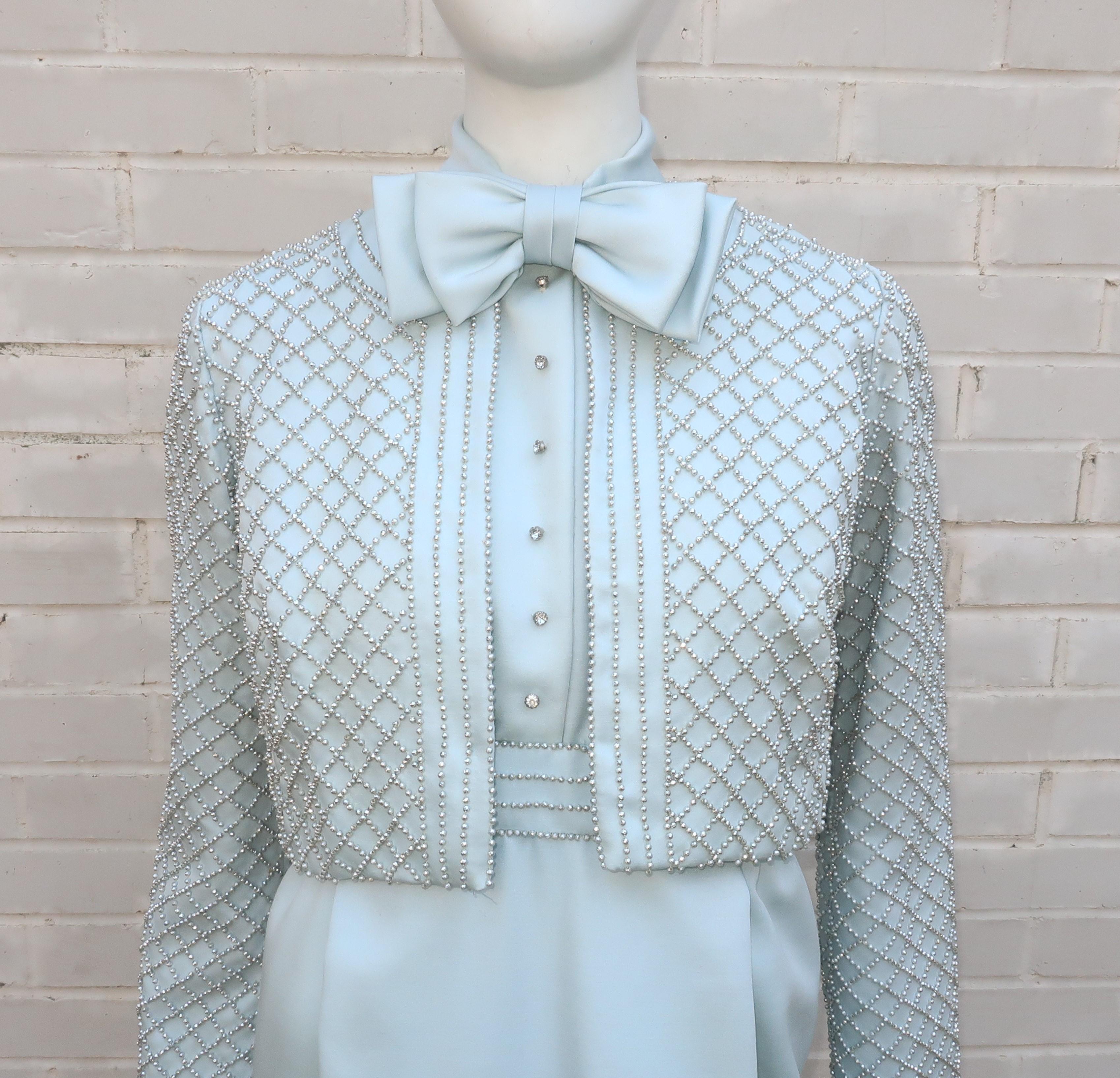 This 1970's two piece dress and jacket ensemble by Victoria Royal is quite a ladylike version of a tuxedo.  The dress zips and hooks at the back with a built in bow tie, silver beading at the waist and a row of rhinestone buttons at the front that