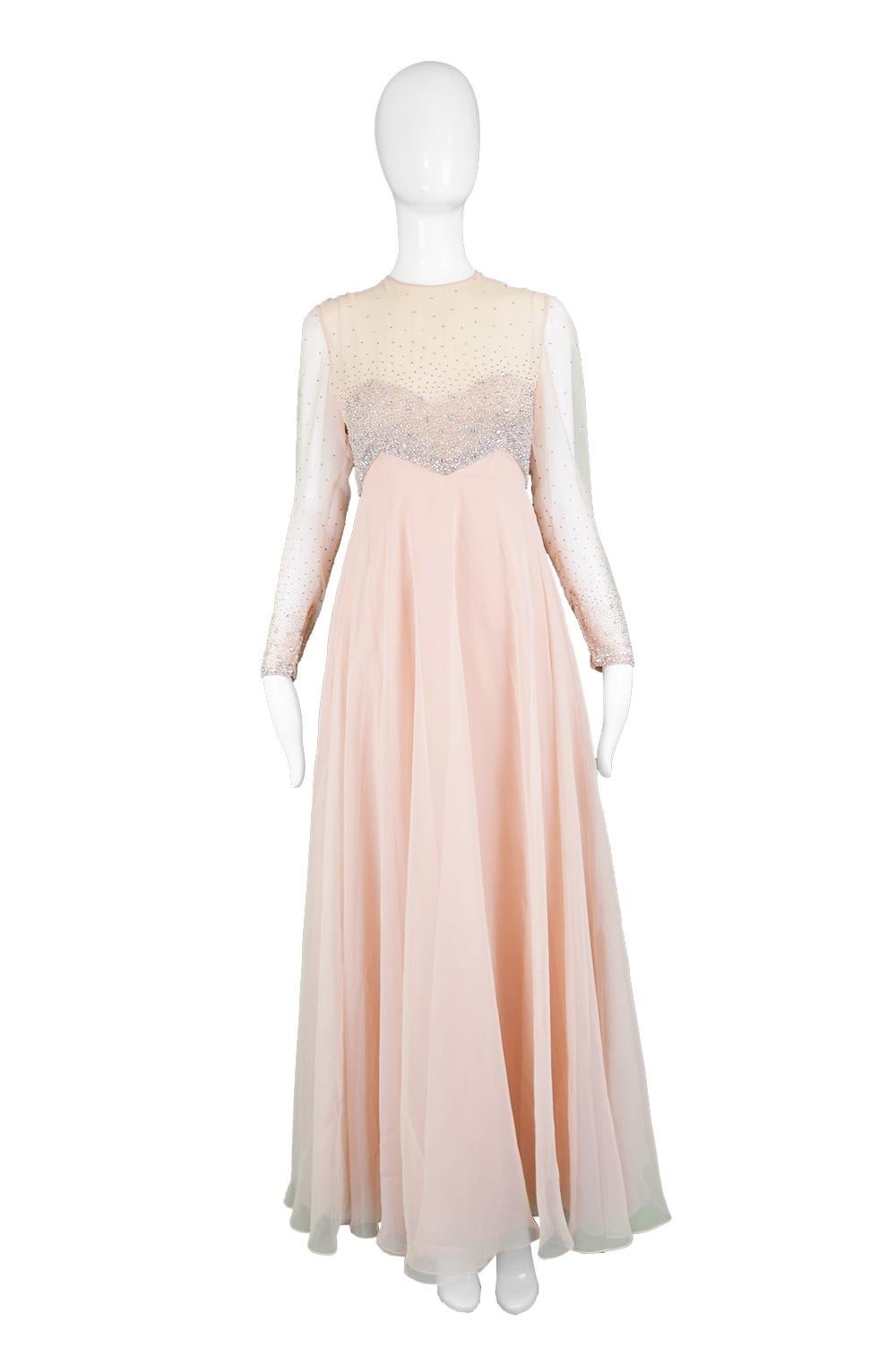 Victoria Royal Vintage Hong Kong Beaded Peach Chiffon Evening Gown, 1960s

Estimated Size: UK 8/ US 4/ EU 36. Please check measurements. 
Bust - 34” / 86cm
Waist - 26” / 66cm
Hips - 40” / 101cm
Length (Shoulder to Hem) - 56”/ 142cm
Shoulder to
