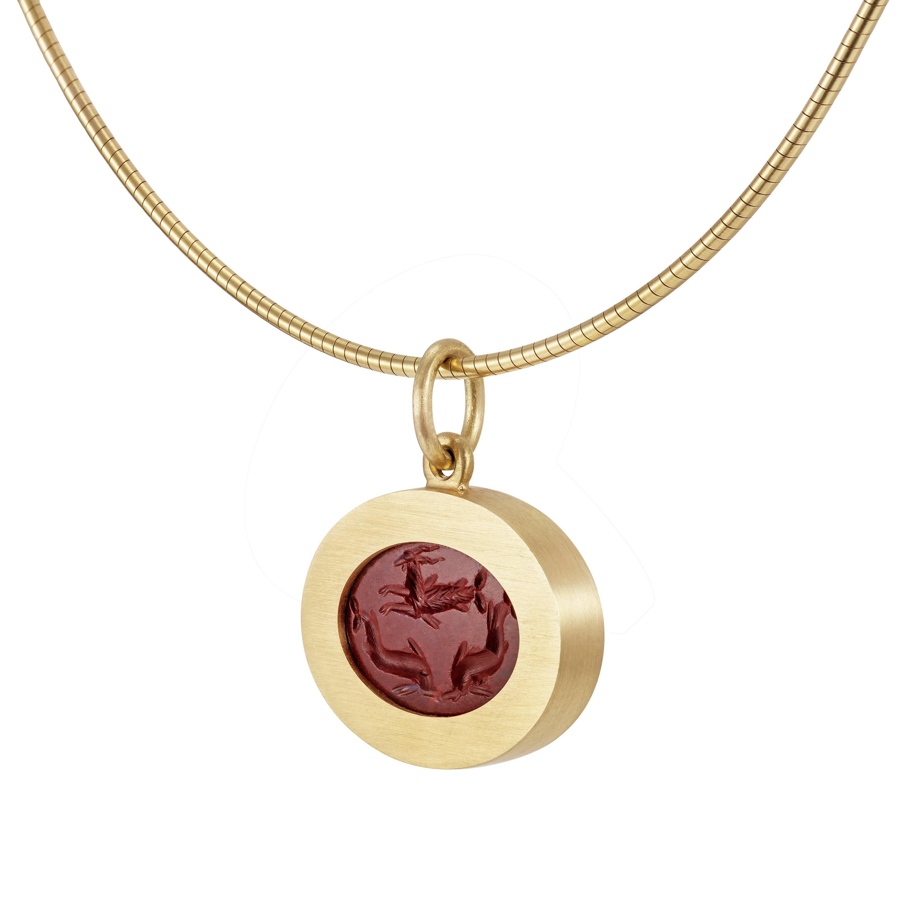 Victoria Strigini (b. 1991)

A contemporary 18k yellow gold pendant necklace featuring a Roman jasper intaglio from the 2nd – 3rd century AD depicting a Capricorn and two dolphins. The animals, symbols of good luck, are gracefully incised in deep