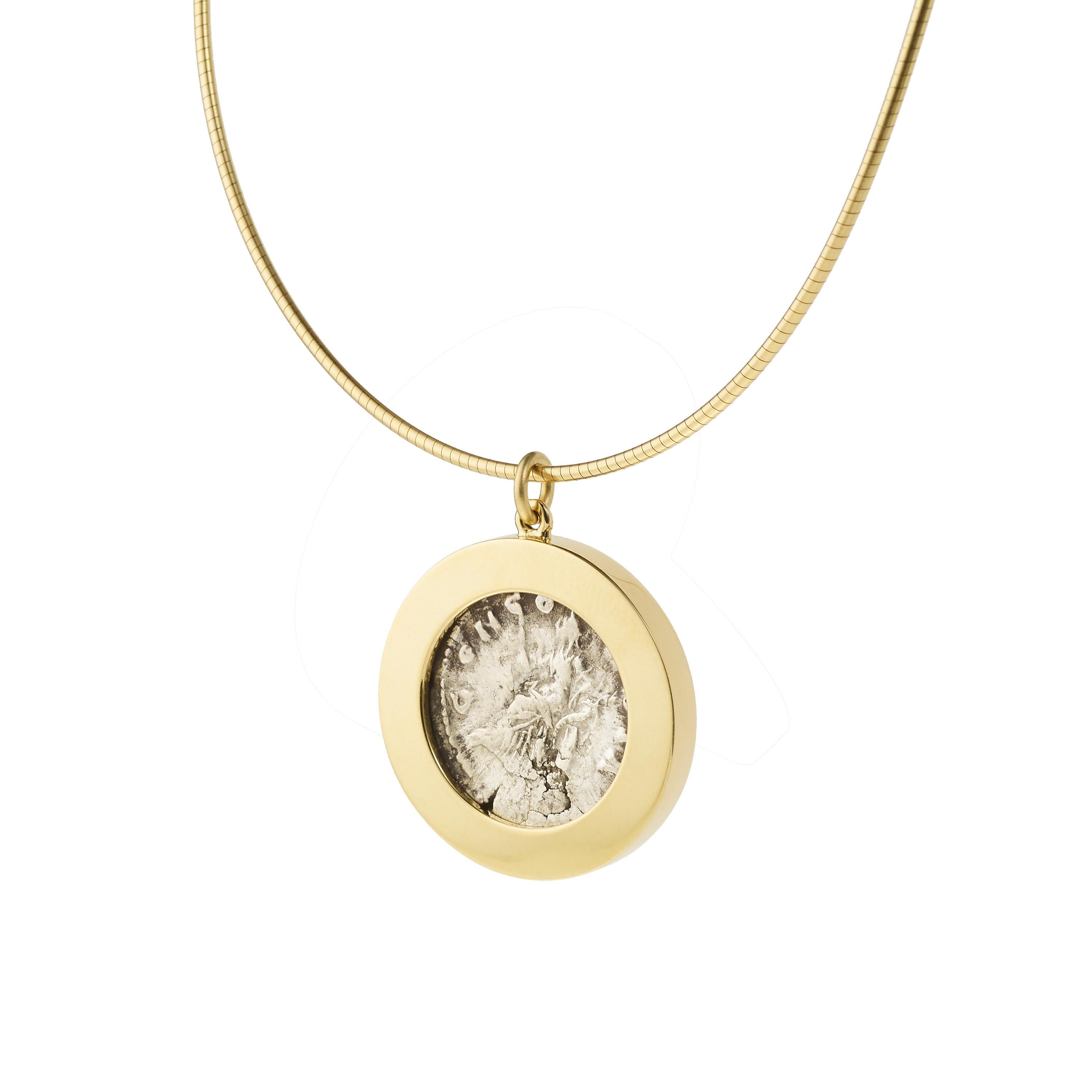 Victoria Strigini (b. 1991)

A contemporary 18k yellow gold pendant necklace featuring a Roman silver coin dating from 161-180 AD, depicting Empress Faustina, wife of Marcus Aurelius. The front of the coin shows a draped bust of Faustina with her