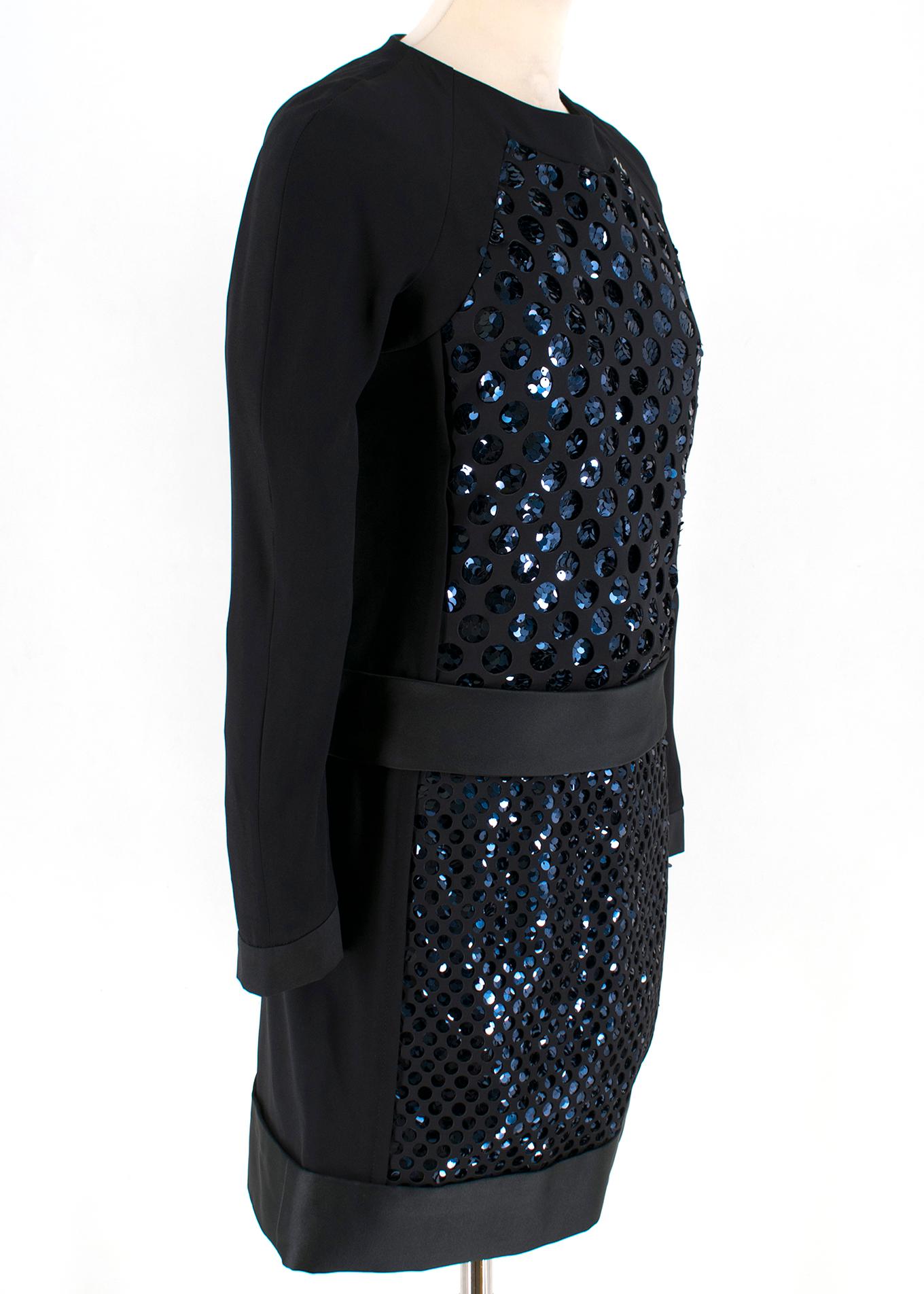 Victoria Beckham Black Laser Cut and Sequin Short Dress

- Laser cut in circles at the front
- Blue/Black sequin under laser cut
- Golden zipper from top to bottom at the back for closure
- Long sleeves
- Round neck

Please note, these items are