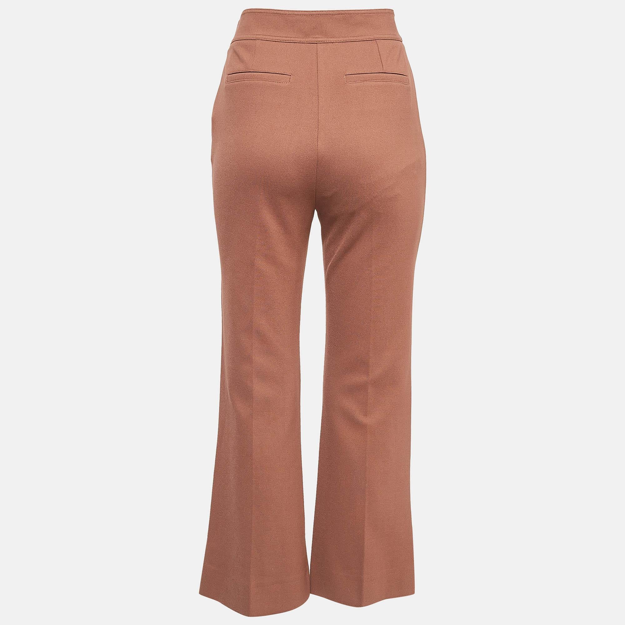 Crafted by Victoria Victoria Beckham, these brown stretch knit flared trousers epitomize contemporary chic. With a sleek silhouette and a flattering fit, they effortlessly blend style and comfort. Perfect for both casual outings and formal