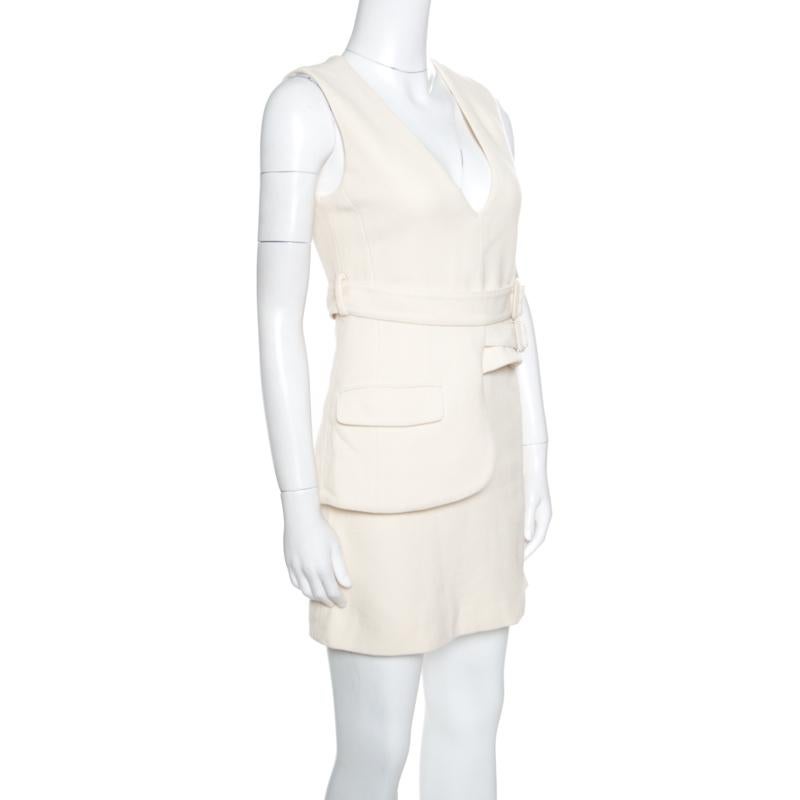 Victoria Beckham is known to create stylish and very sophisticated creations and this sleeveless dress is one that will make you stand out in the crowd. This cream dress is made of 100% wool and features a deep V-neckline, buckle belt detailing on