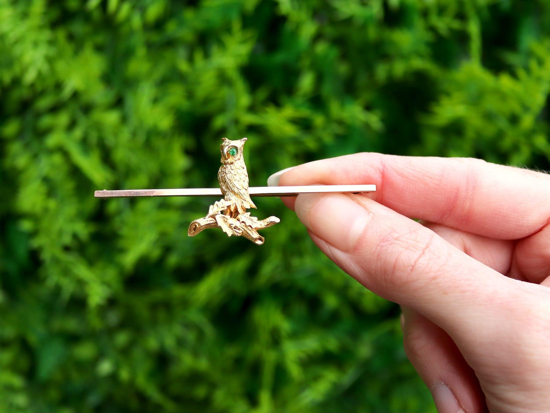 An impressive antique 1890's 0.06 carat emerald and 15 karat yellow gold, 9 karat rose gold and copper 'owl' bar brooch; part of our diverse antique  and estate jewelry collections.

This fine and impressive antique brooch has been crafted in 15k