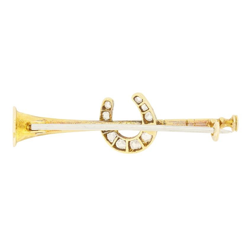 This charming Victorian brooch is designed in the shape of a horn with an intertwining horse shoe. Crafted in 15 carat yellow gold, a collection of ten rose cut diamonds totalling 0.14 carat adorn the horse shoe adding wonderful sparkling