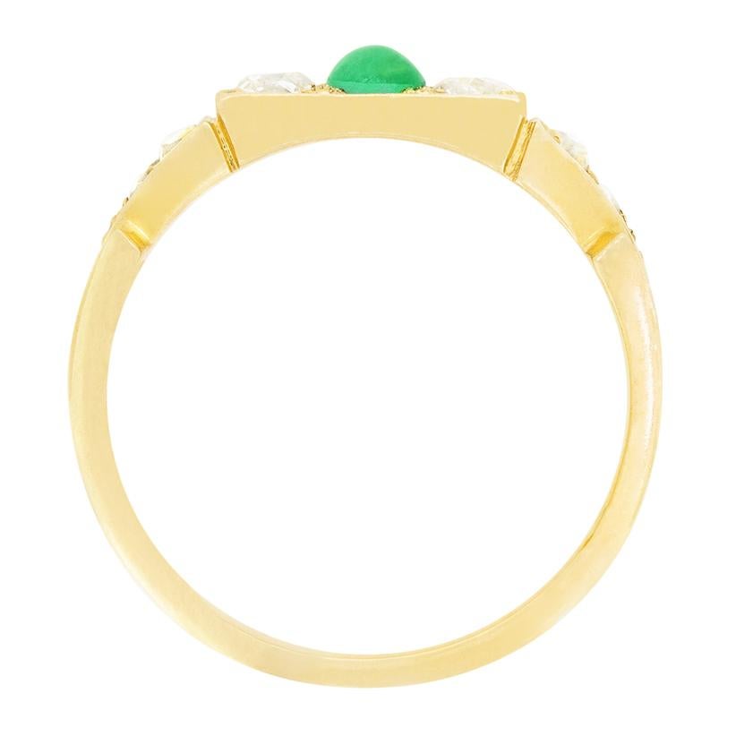 A wonderful Cabochon cut emerald is flanked by old cut diamonds in this beautiful Victorian Ring. Set in 18 carat yellow gold, the emerald sits at 0.20 carat, whilst the flanking diamonds weigh 0.10 carat a piece. Each diamond matches in quality at