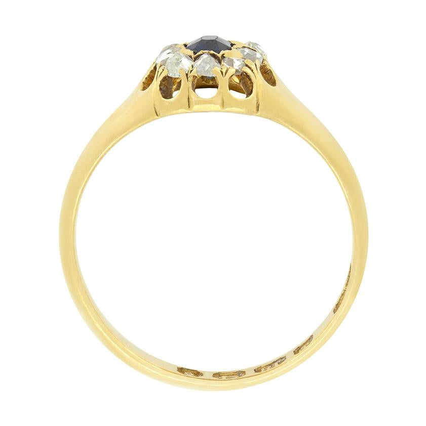 This delightful Victorian Cluster Ring features a single 0.25 carat sapphire at its centre, beautifully claw set in 18 carat yellow gold. Surrounding the sapphire are 0.10 carat total of sparkling rose cut diamonds, arranged in a classic cluster
