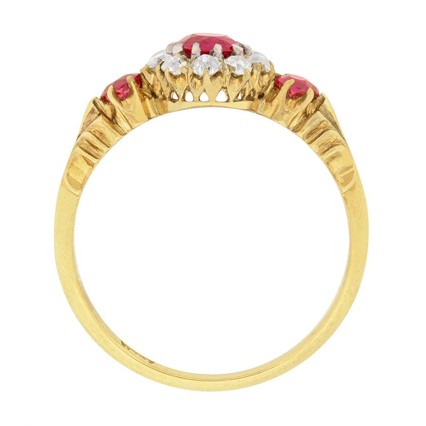 This stunning ruby and diamond ring dates to the 1880s. A 0.40 carat natural Burmese ruby is showcased in the centre of a halo of diamonds. The old cut diamonds total to 0.40 carat, and are F colour and VS clarity. Two 0.15 carat rubies are at