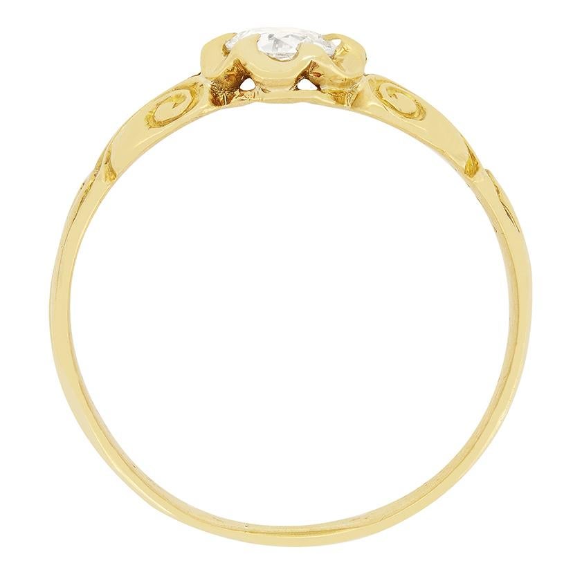 Dating to the 1880s this Victorian solitaire design features a single old cut diamond at it’s centre. The diamond is a 0.40 carat stone of high quality at F in colour and VS2 in clarity. Claw set in 18 carat yellow gold the ring is flanked by