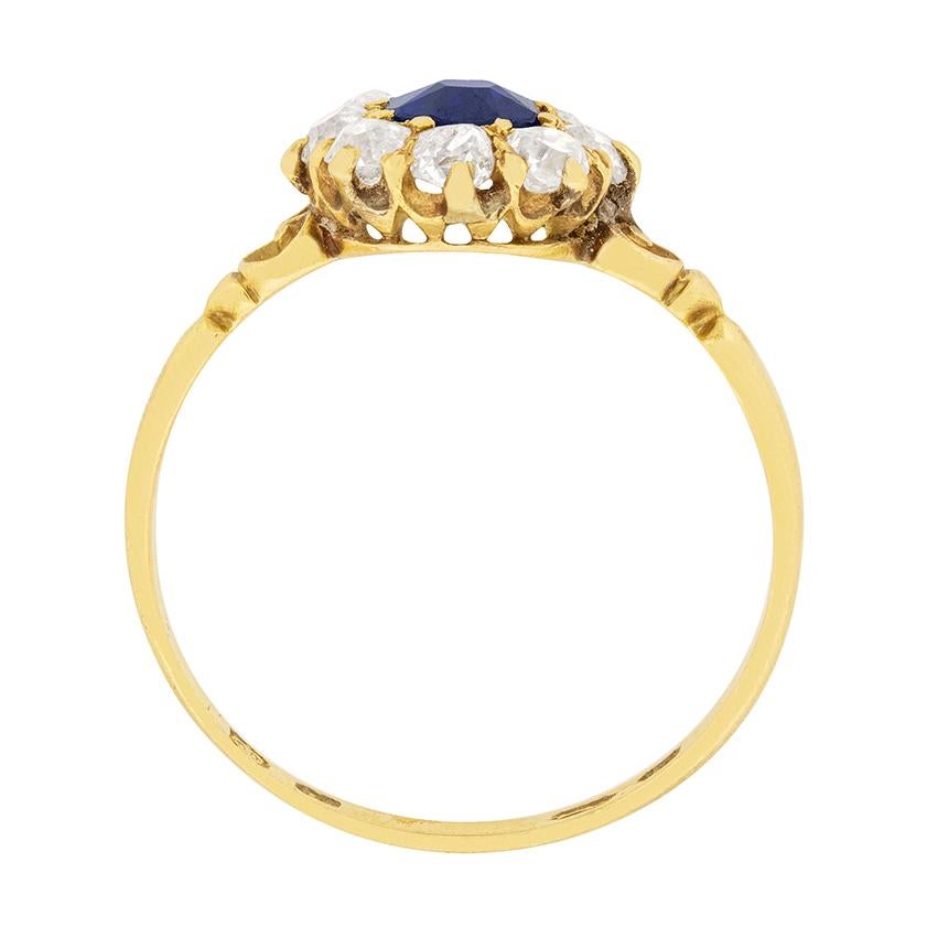This gorgeous sapphire ring was made entirely by hand in the 1900s. The natural deep blue sapphire is old cut, and is 0.40 carat. It is surrounded by eight old cut diamonds, totalling to 0.64 carat. They are great quality, with grades of G colour