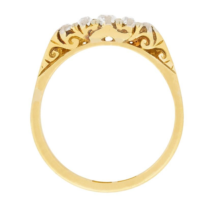 Originating in the 1880s, this classic example of a Victorian era five stone diamond ring is set with five old cut diamonds totalling 0.45 carats. In keeping with period style, the ring's antique 18 carat yellow gold and platinum setting features