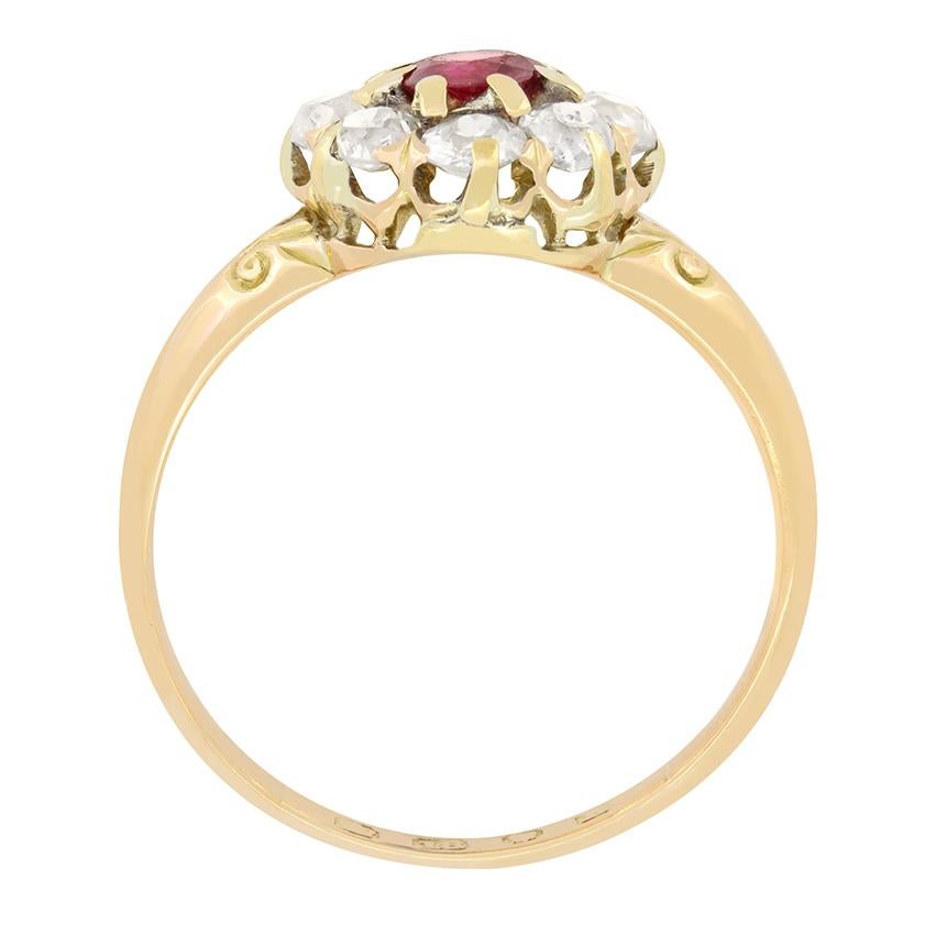 A lovely 0.50 carat ruby is the focal point of this Victorian ring. The old cut ruby is claw set and surrounded by eight old cut diamonds totalling to 1.20 carat. The diamonds match in quality at H in colour and Si in clarity. Beautiful hand carving