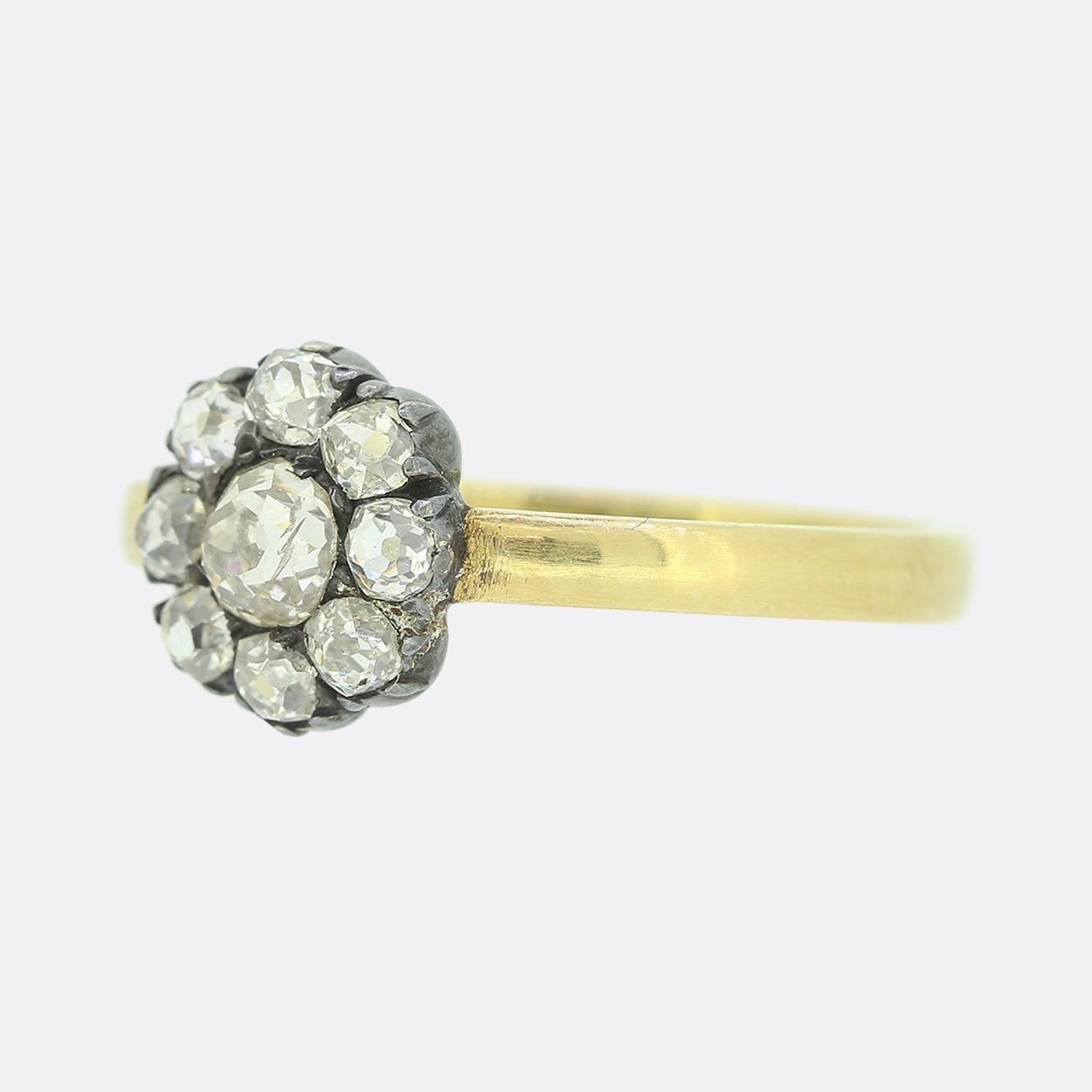 This is a truly wonderful antique diamond cluster ring. The head of the ring dates back to the Victorian era and the diamonds are all bright white chunky old cuts. The central diamond is larger than the surrounding stones and weighs approximately