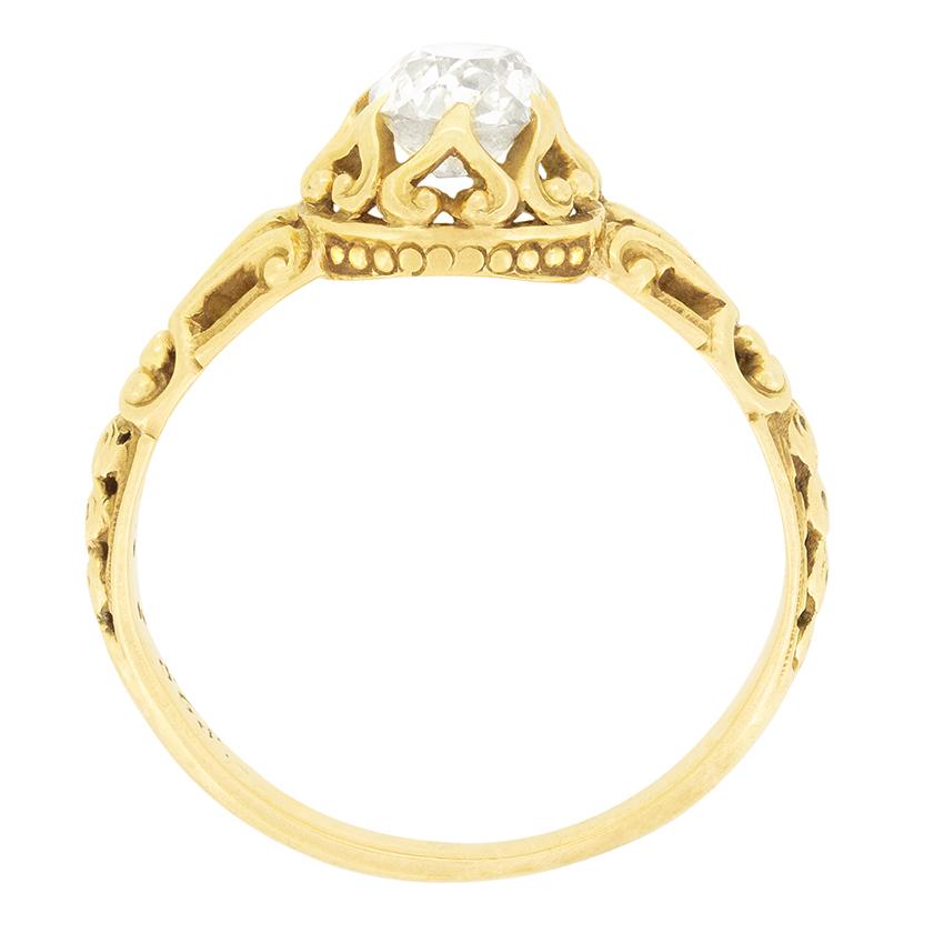 A single old mine cut diamond sits central to this stunning hand carved ring. The diamond is a 0.60 carat stone with a colour of I and clarity of VS1. The stone is set within intricate carved detailing work, with the claw setting work taking on the