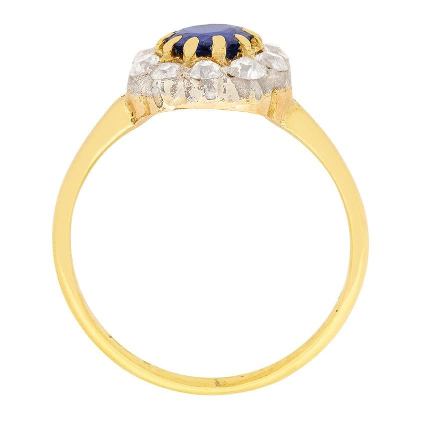 Beautifully hand crafted in the 1880s this Victorian cluster ring centralizes around a  wonderful 0.65 carat Sapphire. Surrounding the sapphire are 0.50 carat of old cut diamonds, which are graded G in colour and VS clarity.  They are uniquely set