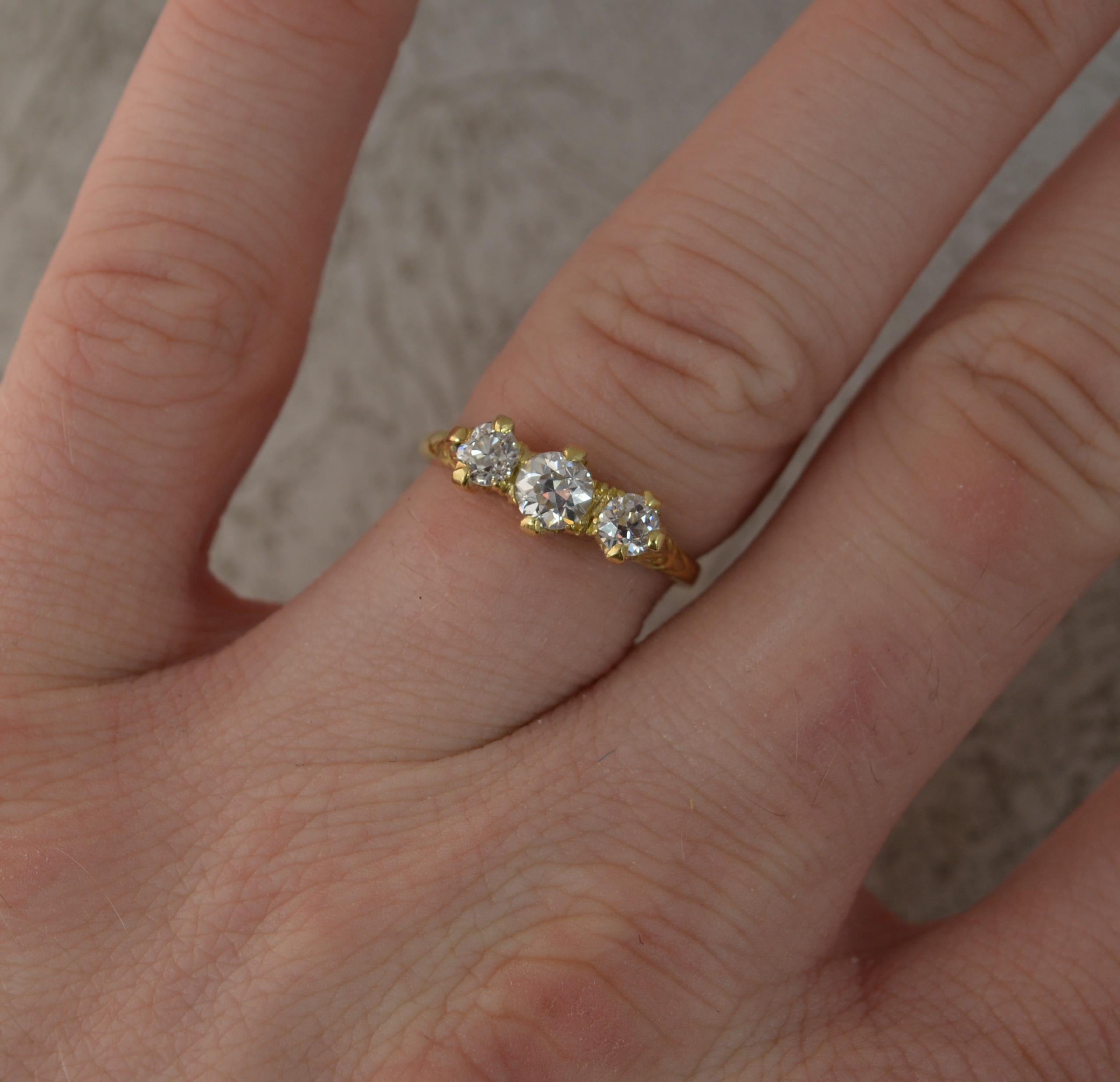 An antique diamond trilogy ring.
Solid 18 carat yellow gold example.
Designed with three natural old European cut diamonds to total 0.75 carats. Very white, bright and sparkly.
Claw set design trilogy.
13mm spread of stones. Protruding 3.5mm off the