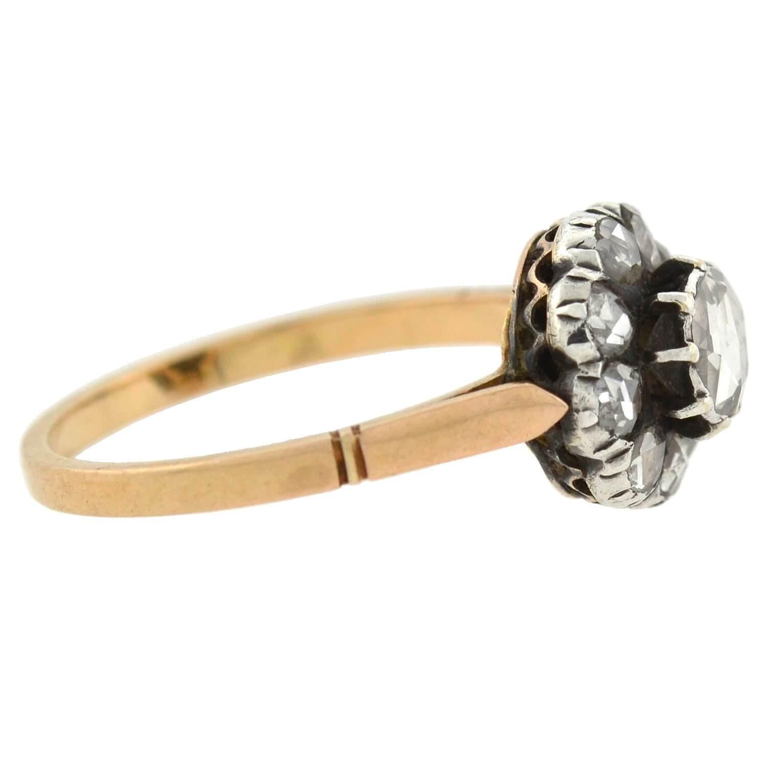 A lovely diamond cluster ring from the Victorian (ca1880) era! The mixed metals design combines a 14kt gold band with a sterling silver centerpiece, creating a lovely 2-tone effect. Decorating the centerpiece is a cluster of 10 old Rose Cut