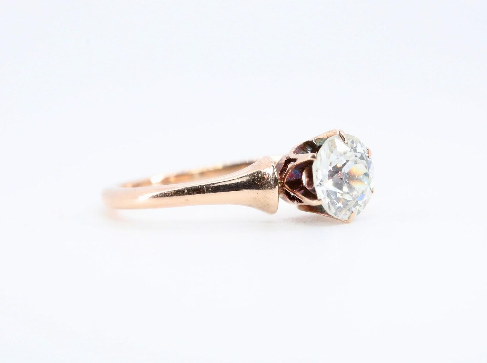 An original victorian period diamond solitaire engagement ring in 14 karat rose gold. Centered by a 0.75 carat old European cut diamond of H color, SI1 clarity. The mounting featuring six stylized claw form prongs in a traditional victorian manner,