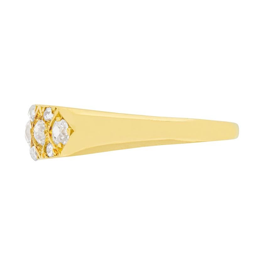 Five sparkling diamonds are set in this 18 carat yellow gold ring. The centre diamond is 0.25 carat, the diamonds to either side are 0.20 carat each, and the diamonds on the ends are 0.10 carat each. Rose cut diamonds accentuate the centre row of