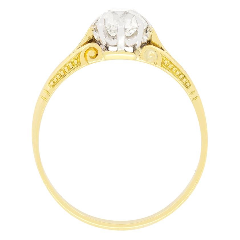 A beautifully traditional engagement ring, this solitaire ring dates to the Victorian period. Boasting a 0.90 carat diamond at it's centre, the old cut stone has been set into a platinum collet. The diamond has an estimated grading of H to I in