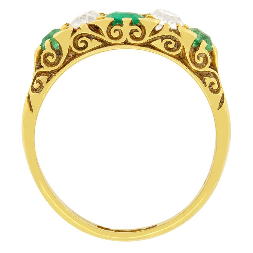 Beautiful detailed carving runs down the shoulders and along the edge of this Victorian emerald and diamond ring. All done by hand, the carving demonstrates the talent acquired in the Victorian era. The claw set emerald in the centre weighs 0.50
