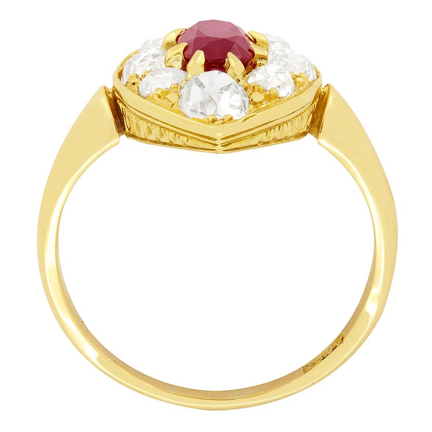 Dating back to the Victorian period is this navette ring featuring a lively red ruby in its centre with old cut diamonds surrounding. The ruby weighs 0.90 carat and is oval in shape. Set to the top and bottom of the ring are the largest diamonds