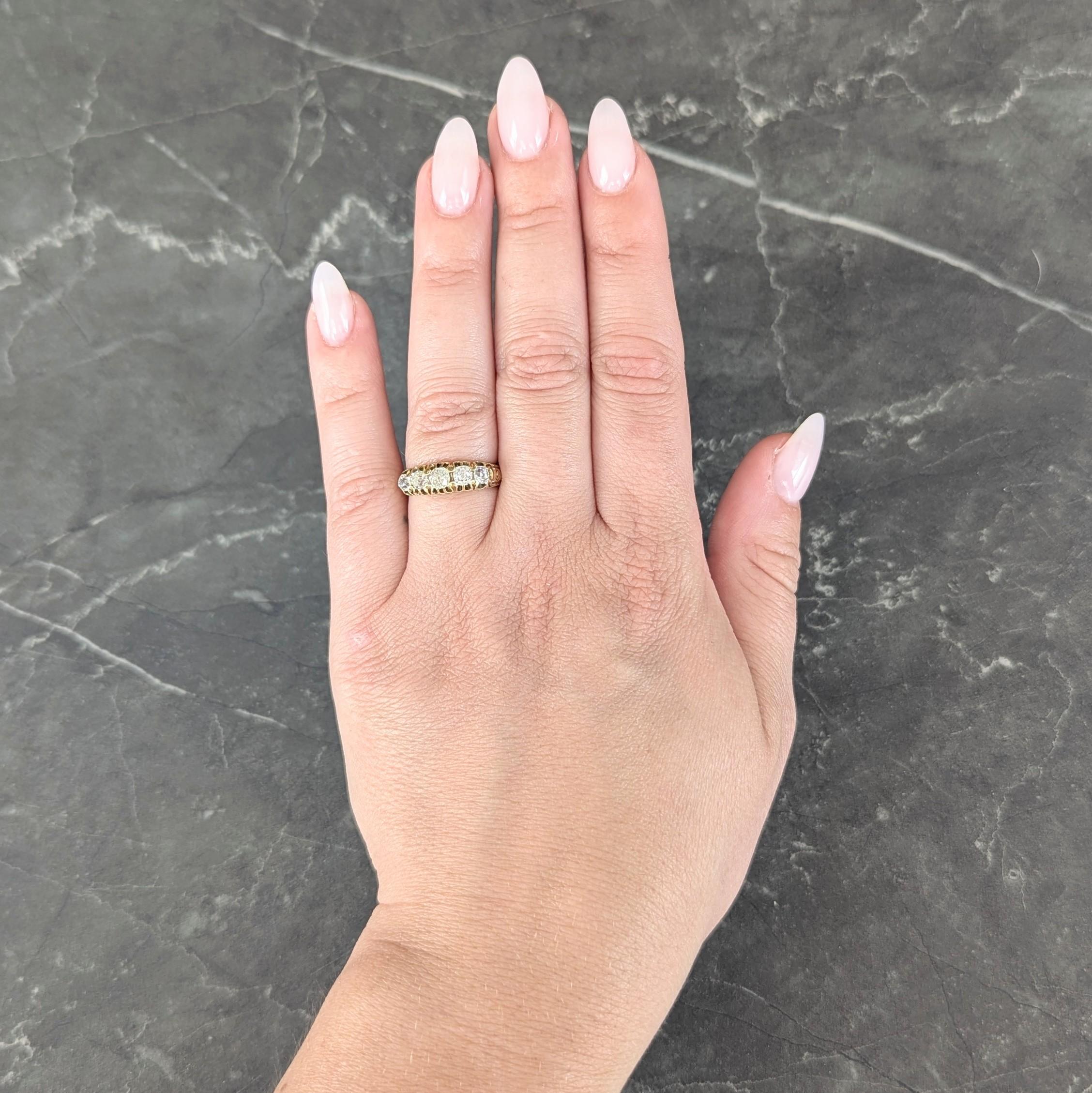 Featuring five old mine cut diamonds set east to west with belcher style prongs
Weighing approximately 0.95 carat total - I to L color with SI2 to I1 clarity
Accented by grooved gallery and flanked by scroll motif shoulders
Tested as 18 karat