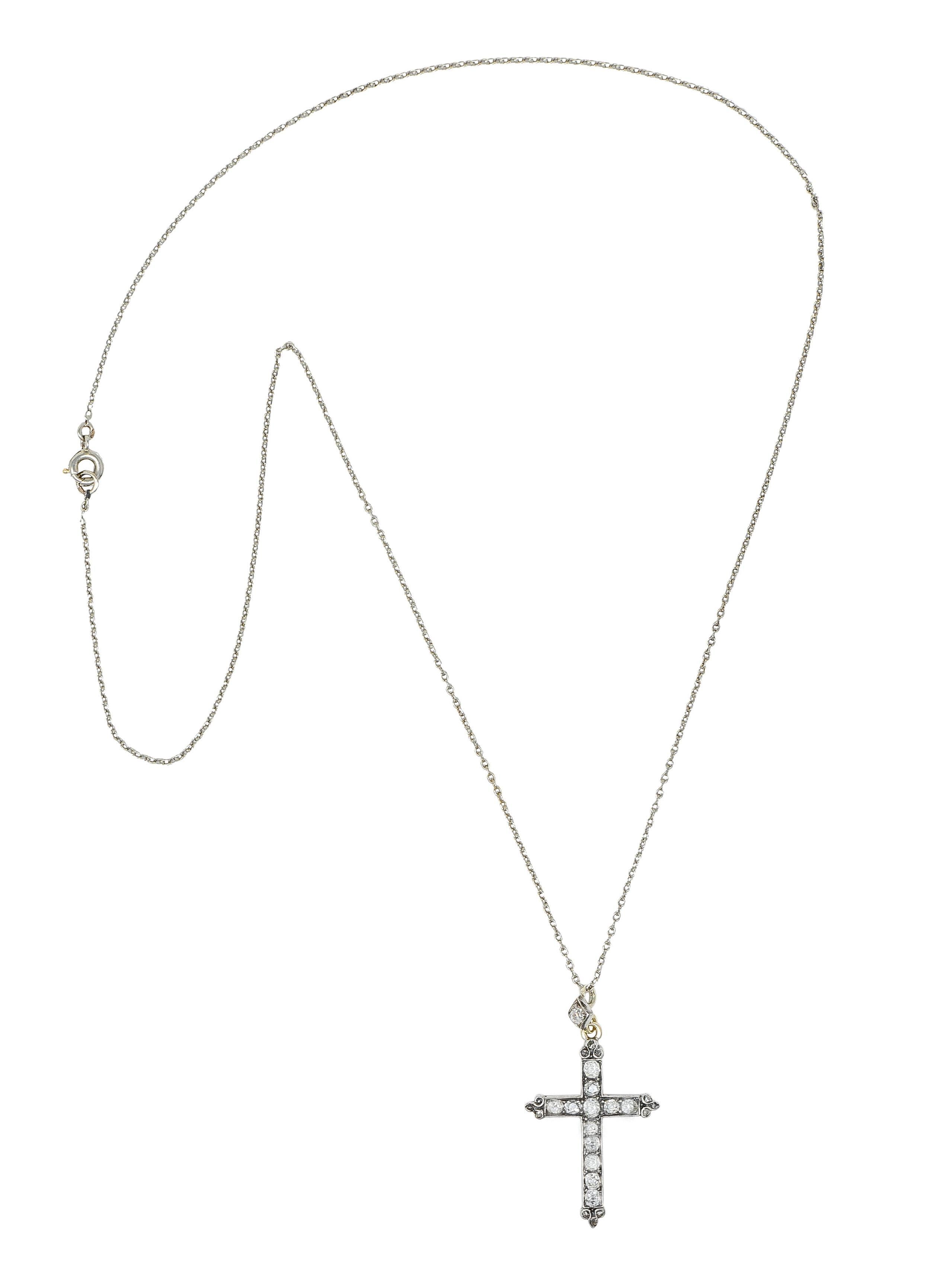 Designed as a 1.5 mm cable link white gold chain suspending a stylized silver-topped cross pendant 
With a diamond-shaped surmount and featuring bead set old mine and rose cut diamonds
Weighing approximately 0.95 carat total - I to M in color and