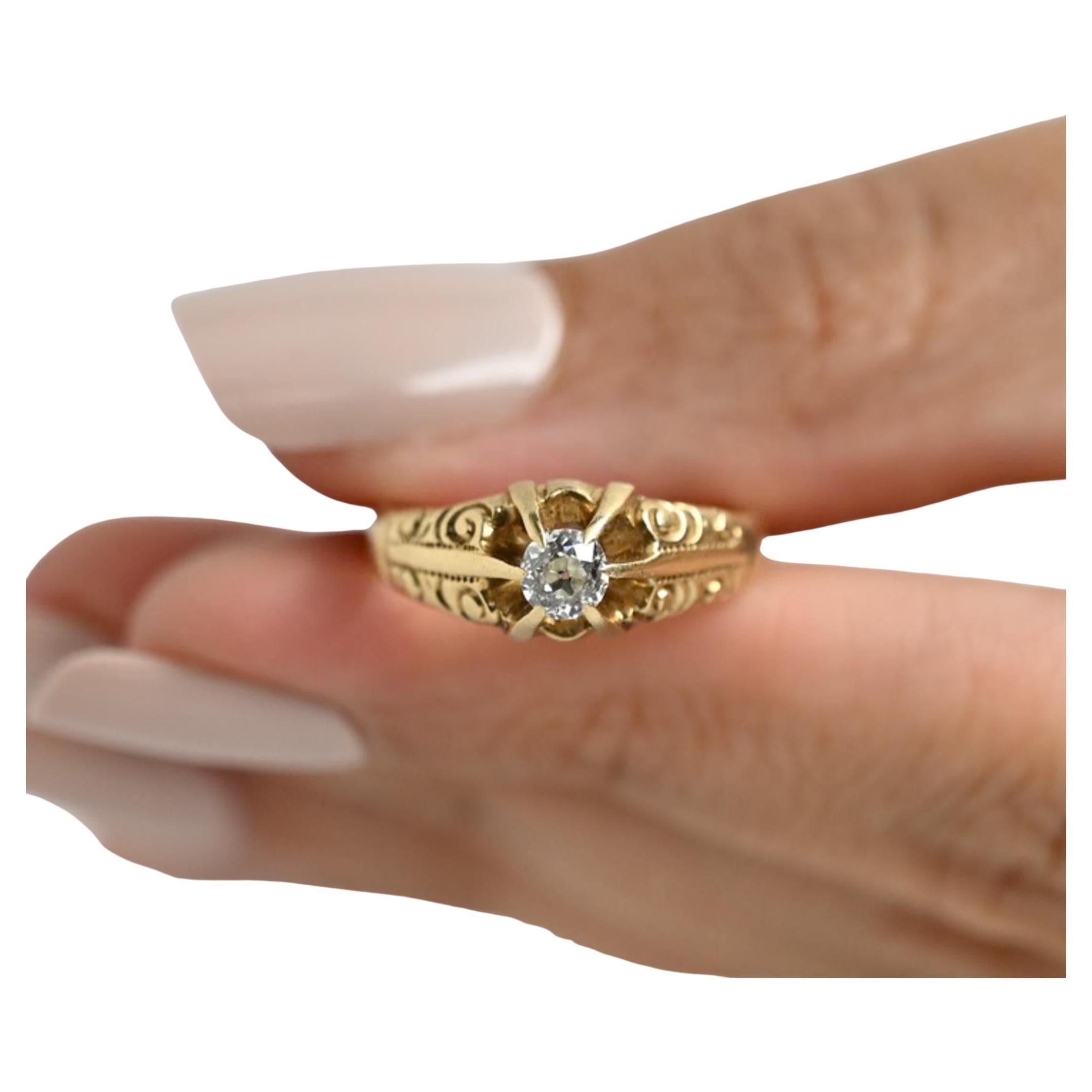 Experience the elegance of the Victorian era with this stunning classic-style ring. Skillfully crafted in 14K yellow gold, the tapered shanks showcase intricate flowing scroll details, lending an artistic flair to the piece. At the heart of it all,