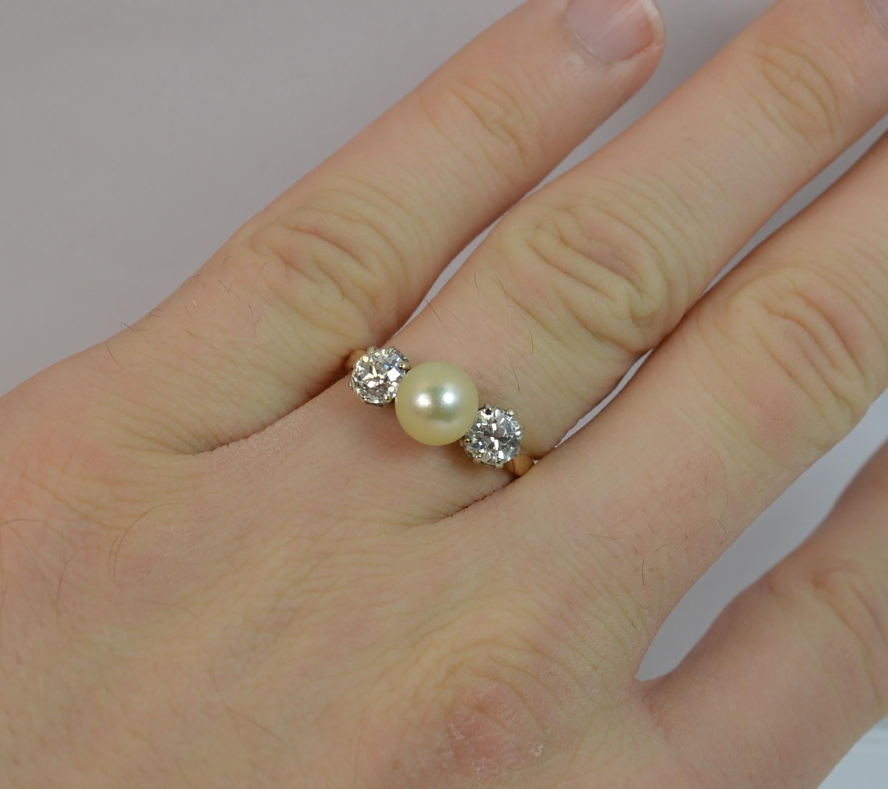 

A true Victorian period trilogy ring. Solid 18 carat yellow gold example with platinum claws for the diamonds.

​Designed with a large pearl to the centre, 6.9mm diameter. A further old cut diamond is set to each side, approx 0.50 carats each,