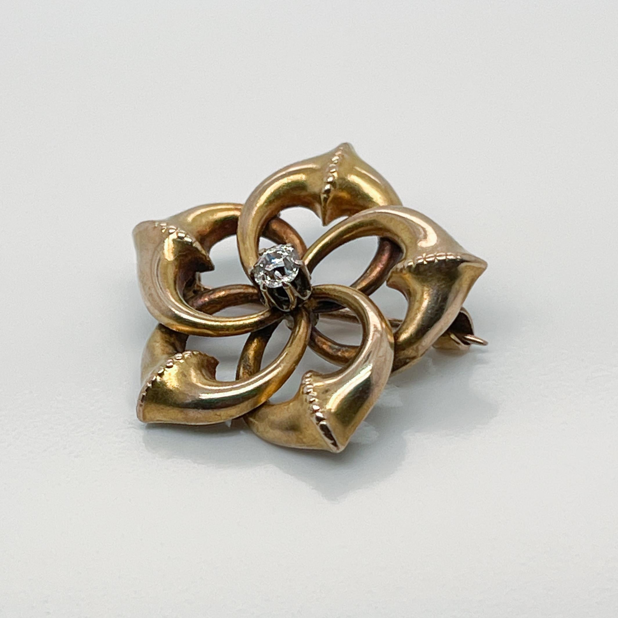 A fine Victorian brooch.

With interlocking gold circles that create a star or snowflake like shape. 

A round rose cut white diamond is prong set at the center of the pin.

Simply a wonderful, antique brooch!

Date:
19th Century

Overall