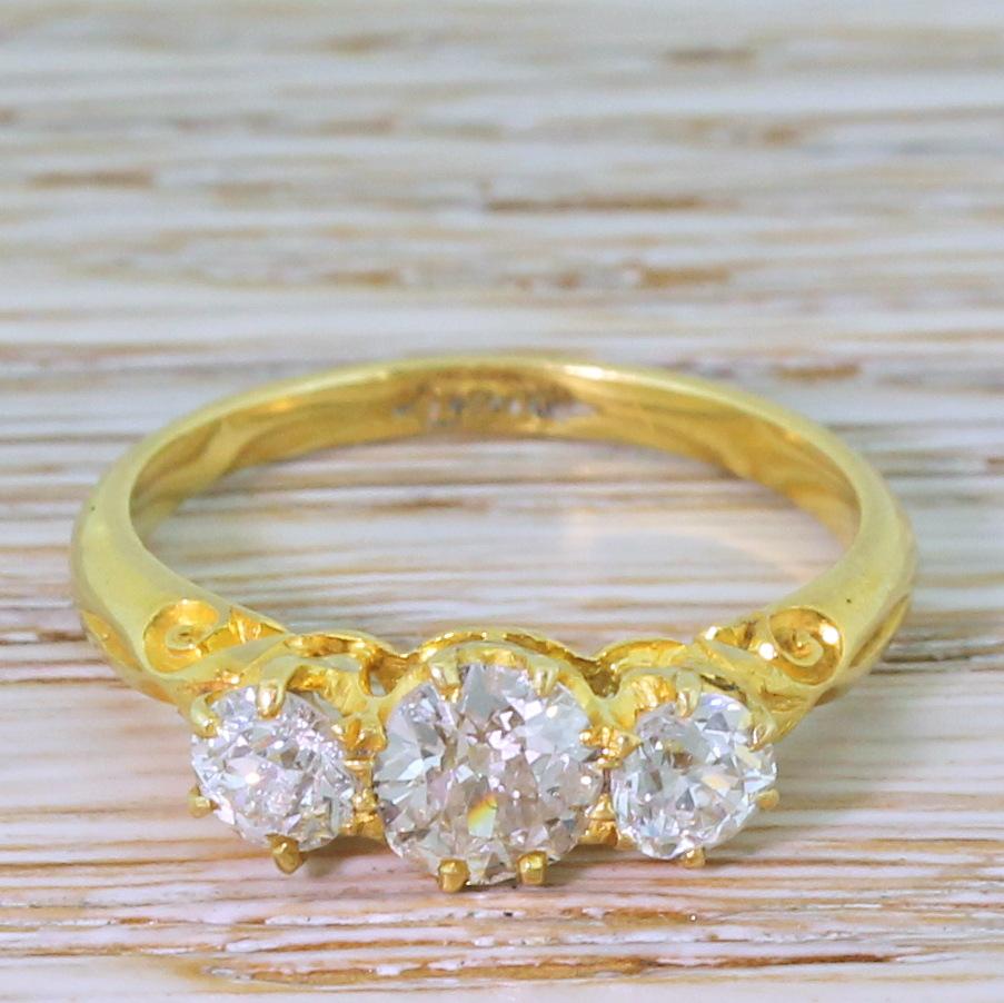 A high quality, high class Victorian three stone ring. Each of the well match old mine cut diamond is exceptionally white and bright, with a the slightly larger 0.50 carat (approx.) stone in the centre balanced by a pair of quarter carat (approx.)