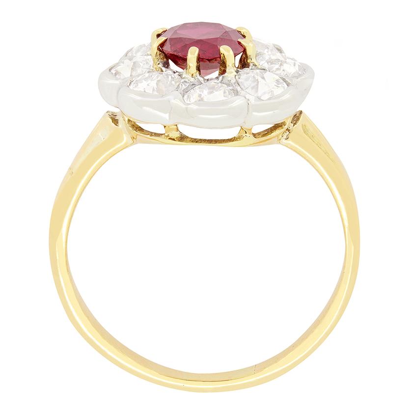 This Victorian Ruby & Diamond Ring is an exquisite piece, showcasing a deep red ruby with Thailand origin. The enchanting natural ruby is a 1.00 carat oval cut stone and is claw set in 15 carat yellow gold. It is then enveloped by a halo of eight