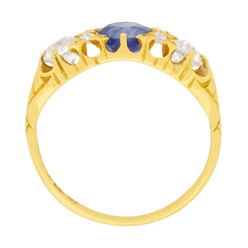 This gorgeous Victorian sapphire and diamond three stone ring is full of Victorian charm. The old cut sapphire is a vibrant blue colour. Two old cut diamonds are 0.35 carat each, and are G colour and VS clarity. The 18 carat yellow gold setting has