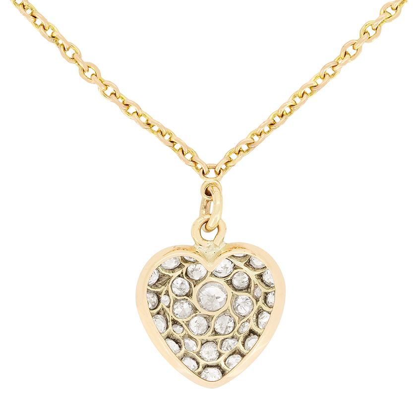 Encrusted with diamonds, this Victorian pendant is beautiful. The heart shaped design centres around an old cut diamond of 0.15 carat which is surrounded by multiple stones of various sizes. Totalling 1.05 carat the diamonds range in colour from G
