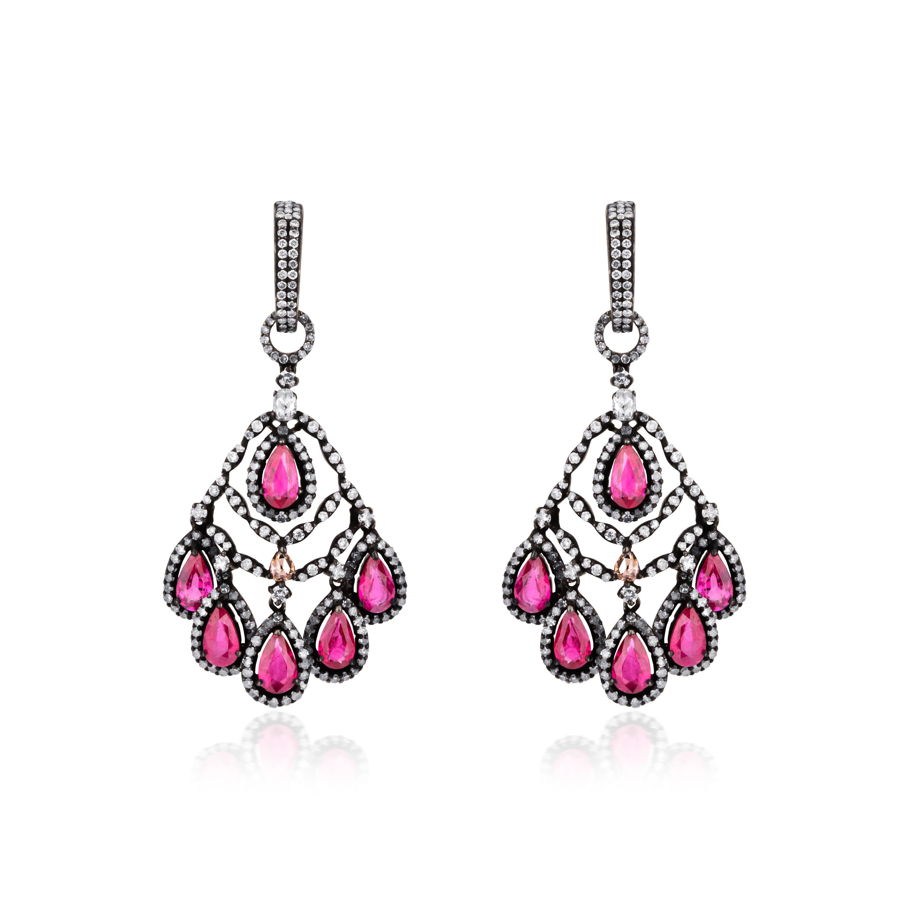 Shimmy your way with these lovely Victorian chandelier earrings. The top of the drop has curved rows of diamond from which hangs drops of pear shaped ruby. Each piece has six pear shaped rubies. The surmount is embellished with rows of round