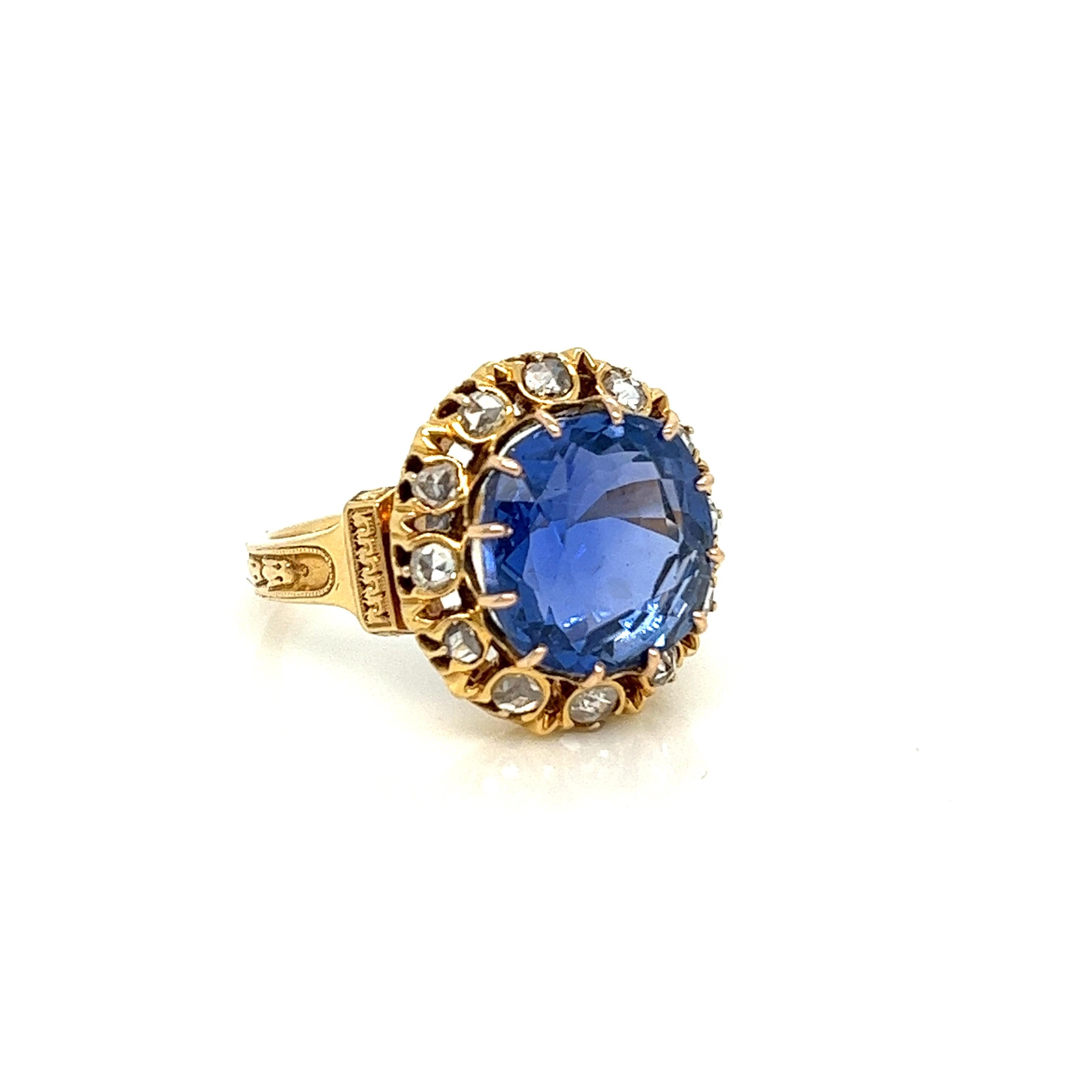 We can just stare at this buttery gold and blue combination all day! A sizeable 10.74 carat Burmese sapphire centers this Victorian-era piece. The stone is graded as unheated by SSEF and has the most beautiful blue hue. A halo of antique rose cuts